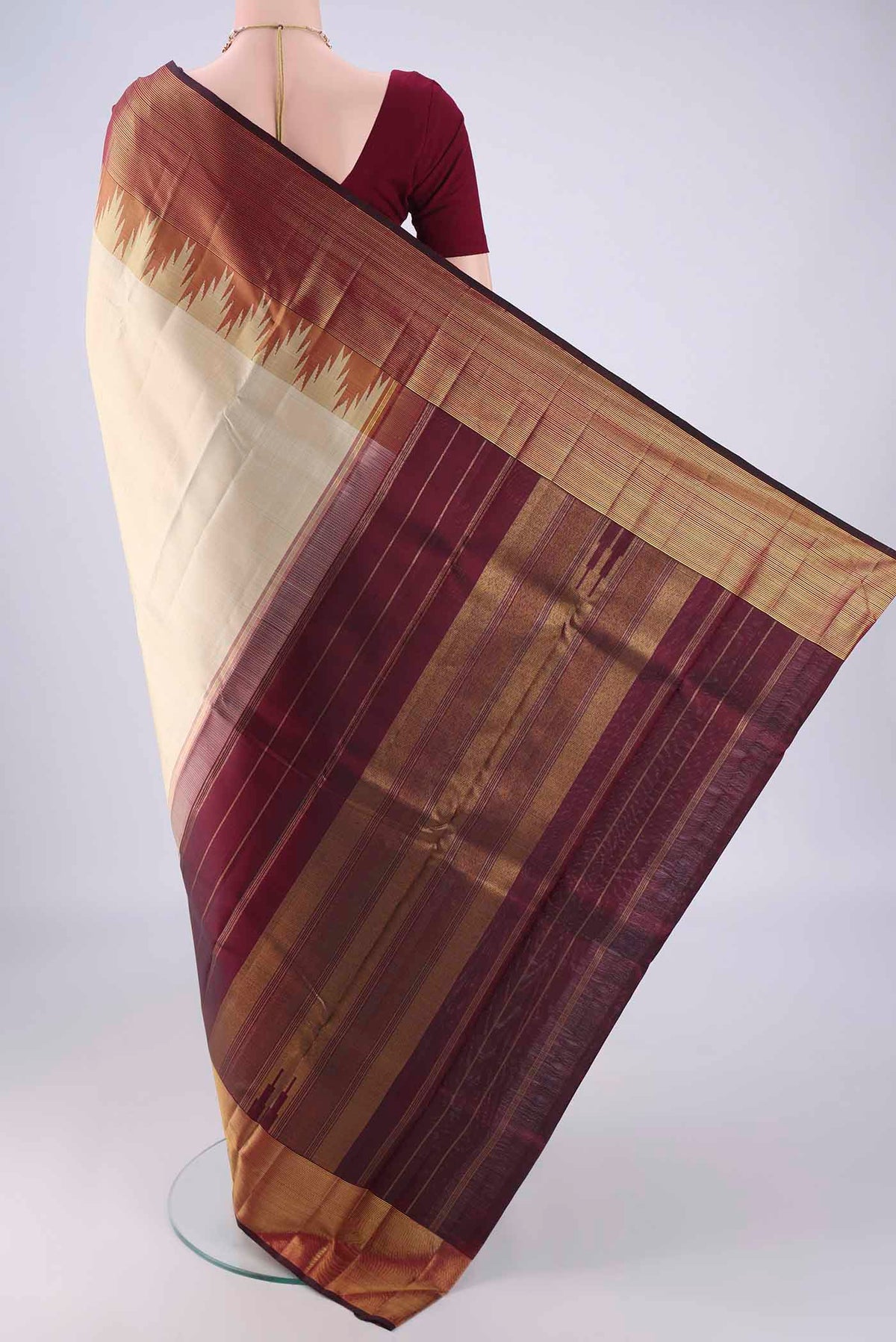 Flat view of Cream Kanjivaram Silk Saree with Plain Body and Temple Border. 