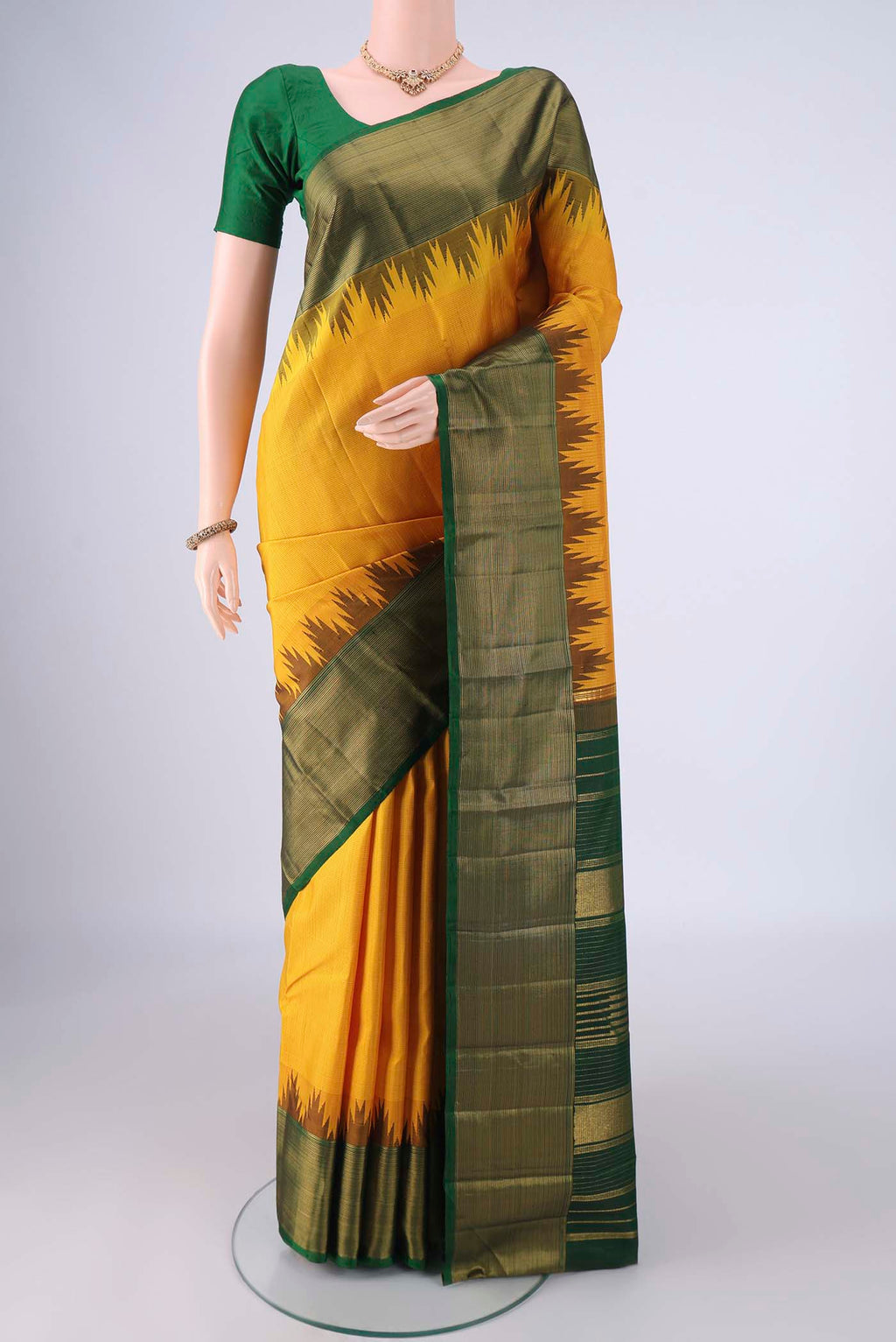 Yellow Kanjivaram Silk Saree with Plain Body and Temple Border.  displayed on a mannequin