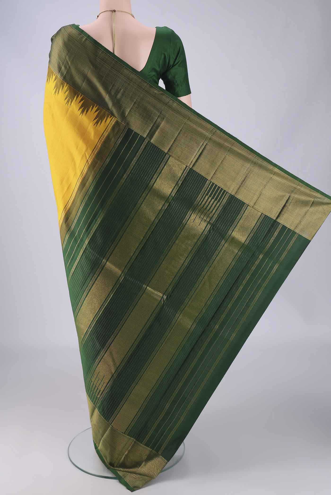 Flat view of Yellow Kanjivaram Silk Saree with Plain Body and Temple Border. 