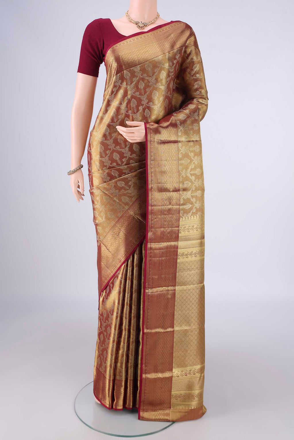 Golden Dual Tone Kanchipuram Tissue Silk Saree with Zari Brocade on the body and Zari Border.  displayed on a mannequin