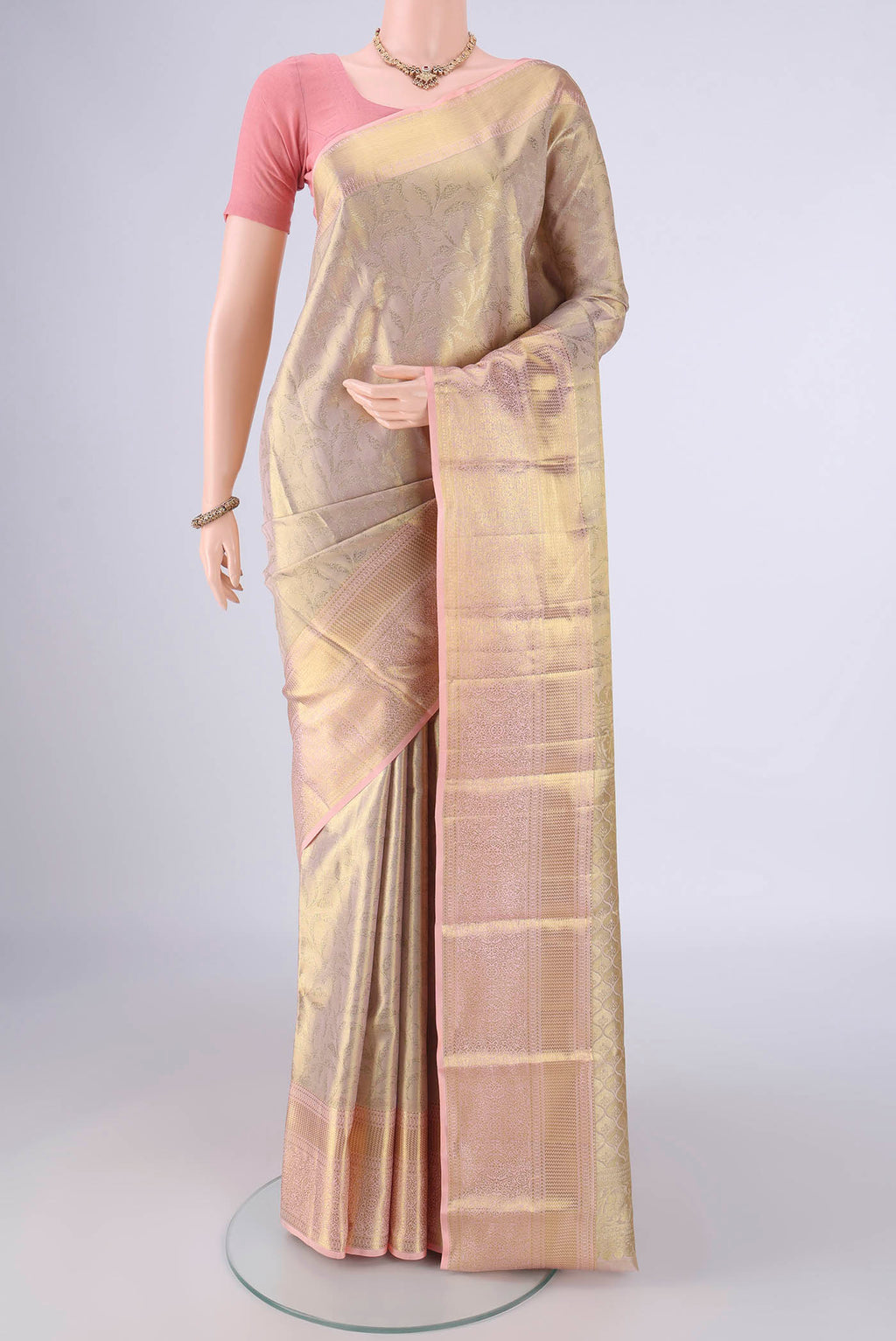 Golden Dual Tone Kanchipuram Tissue Silk Saree with Zari Brocade on the body and Zari Border.  displayed on a mannequin