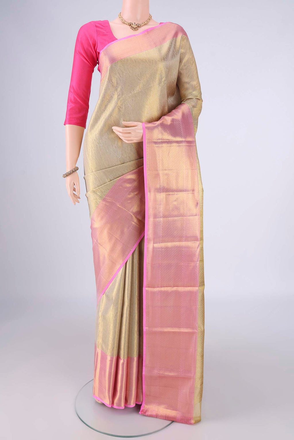Golden Kanchipuram Tissue Silk Saree with Zari Brocade on the body and Zari Border.  displayed on a mannequin