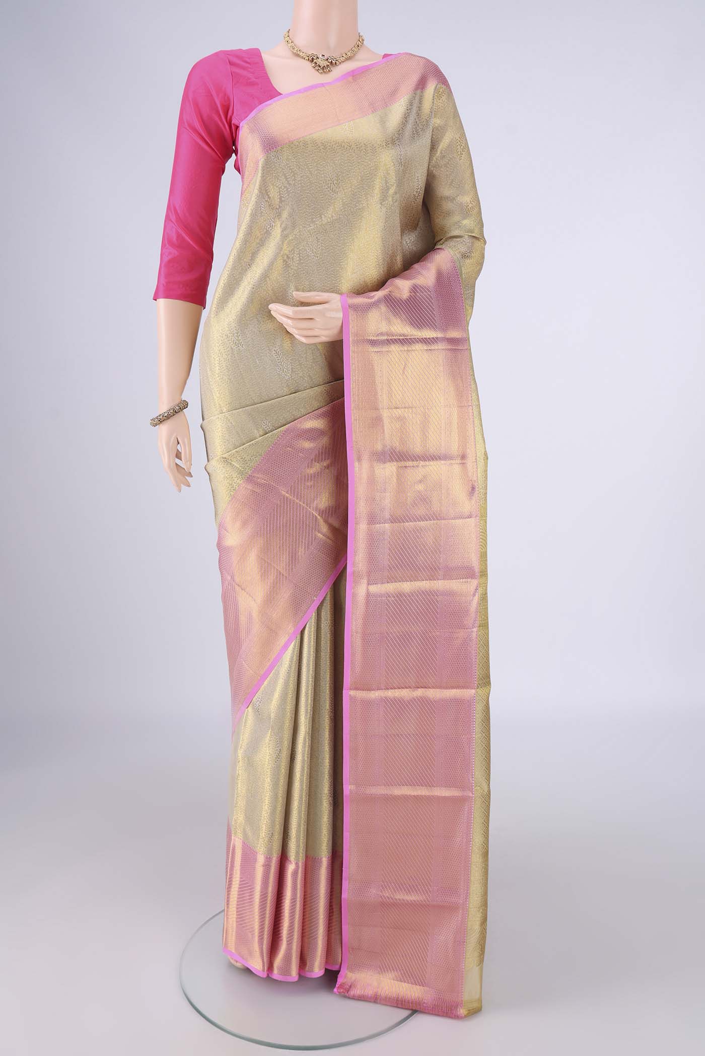 Golden Kanchipuram Tissue Silk Saree with Zari Brocade on the body and Zari Border.  displayed on a mannequin