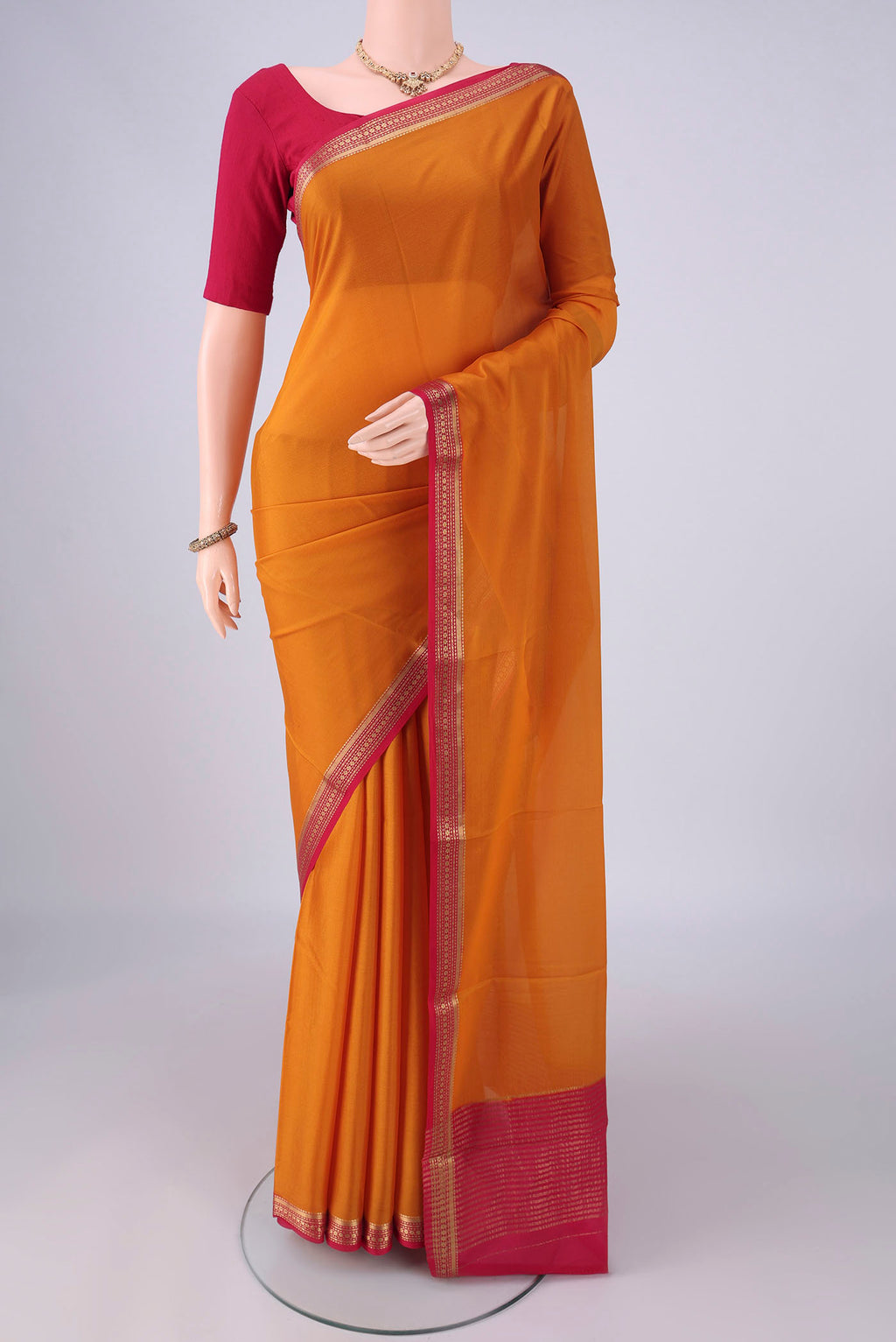 Mustard Mysore Crepe Saree with Plain Body and Zari Border.  displayed on a mannequin