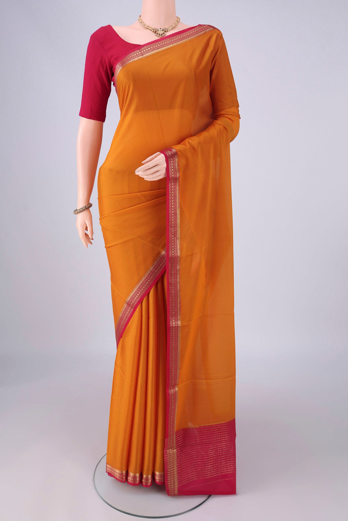 Mustard Mysore Crepe Saree with Plain Body and Zari Border.  displayed on a mannequin