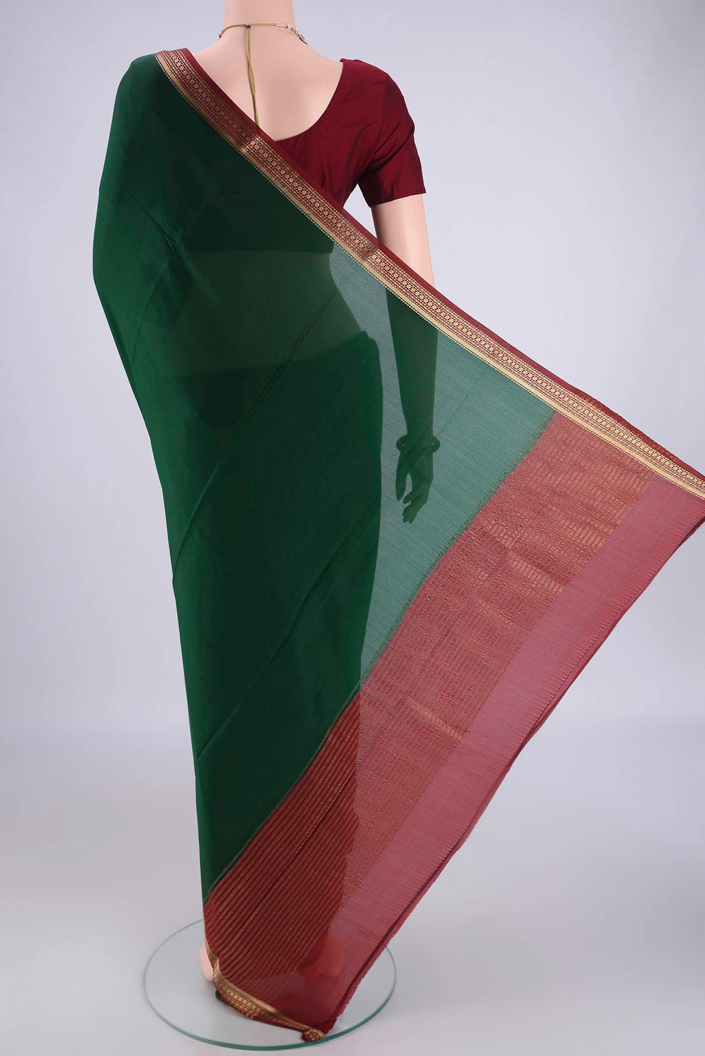 Flat view of Bottle Green Mysore Crepe Saree with Plain Body and Zari Border. 