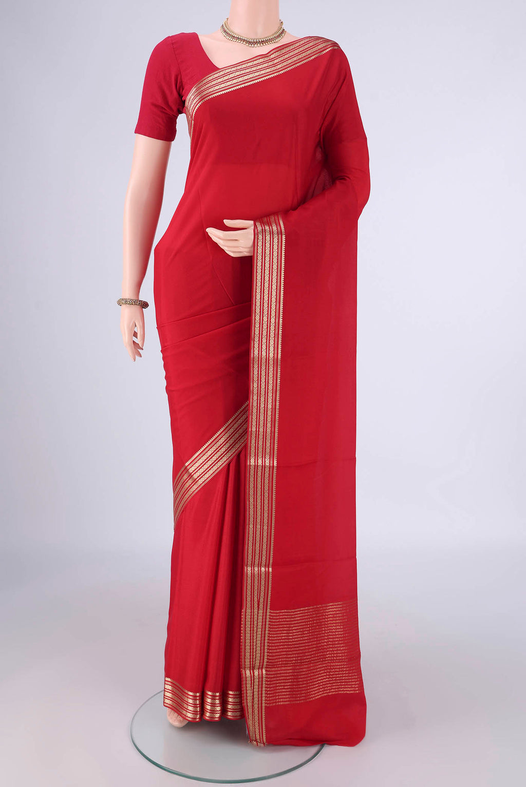 Red Mysore Crepe Saree with Plain Body and Zari Border.  displayed on a mannequin