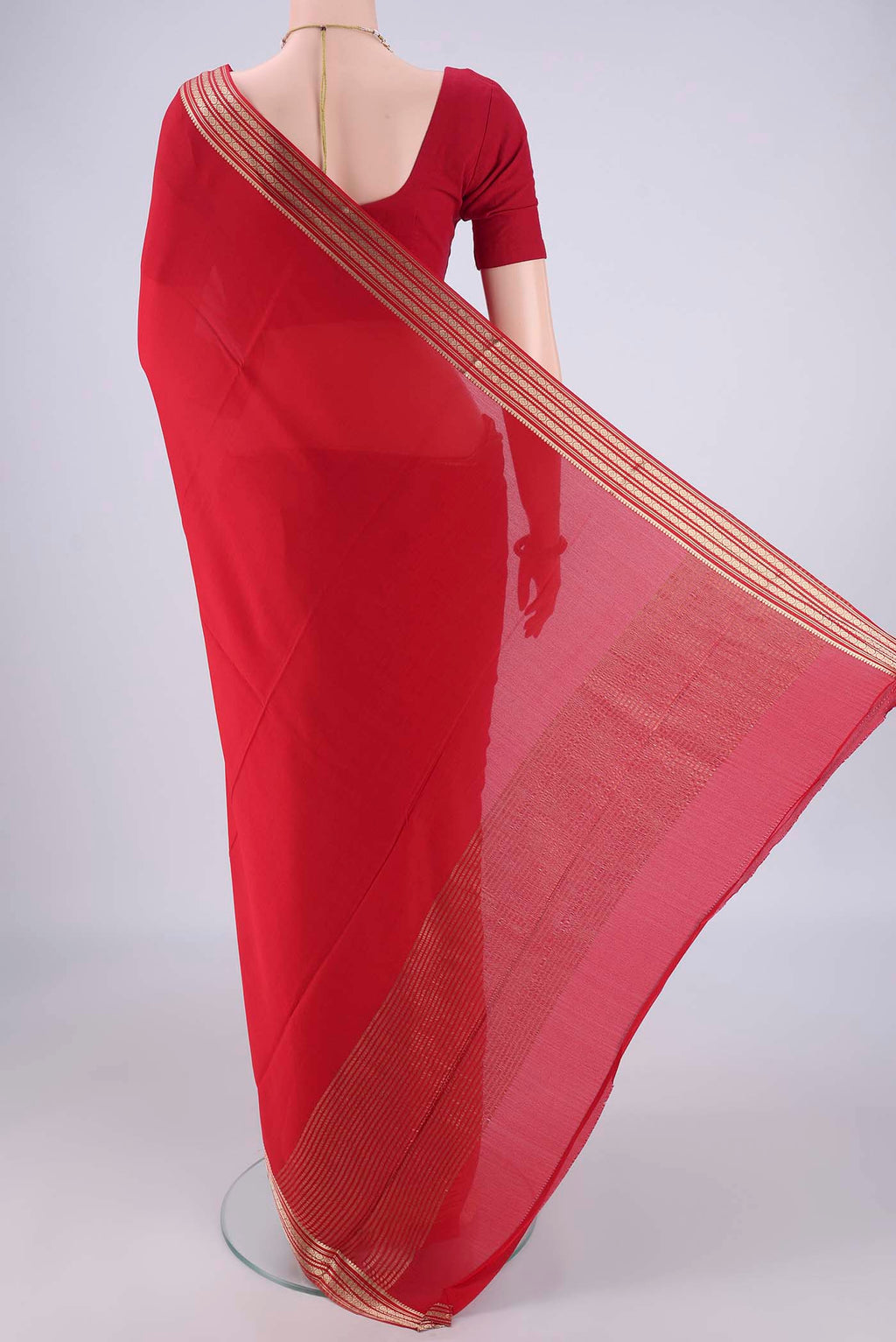 Flat view of Red Mysore Crepe Saree with Plain Body and Zari Border. 