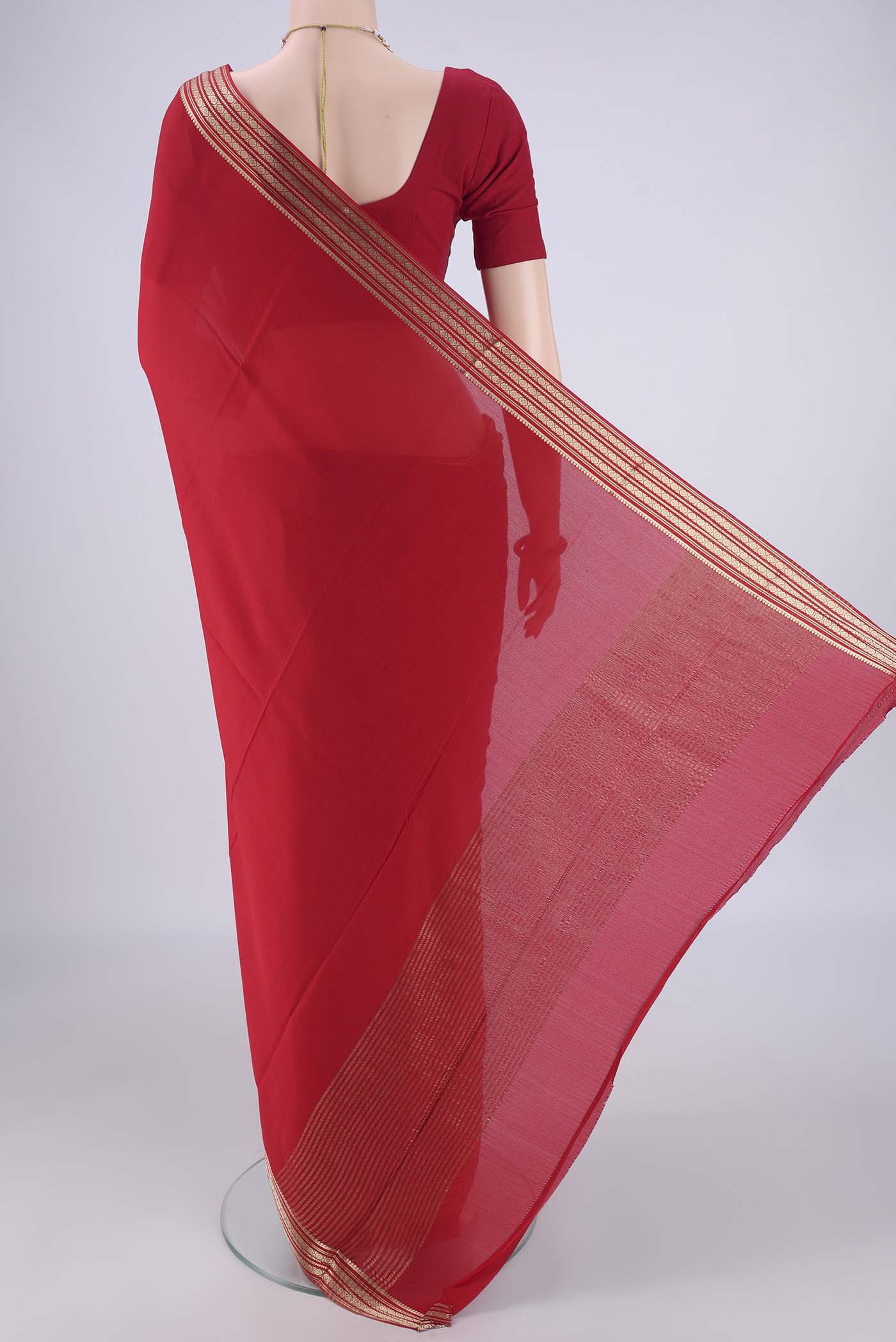 Flat view of Red Mysore Crepe Saree with Plain Body and Zari Border. 