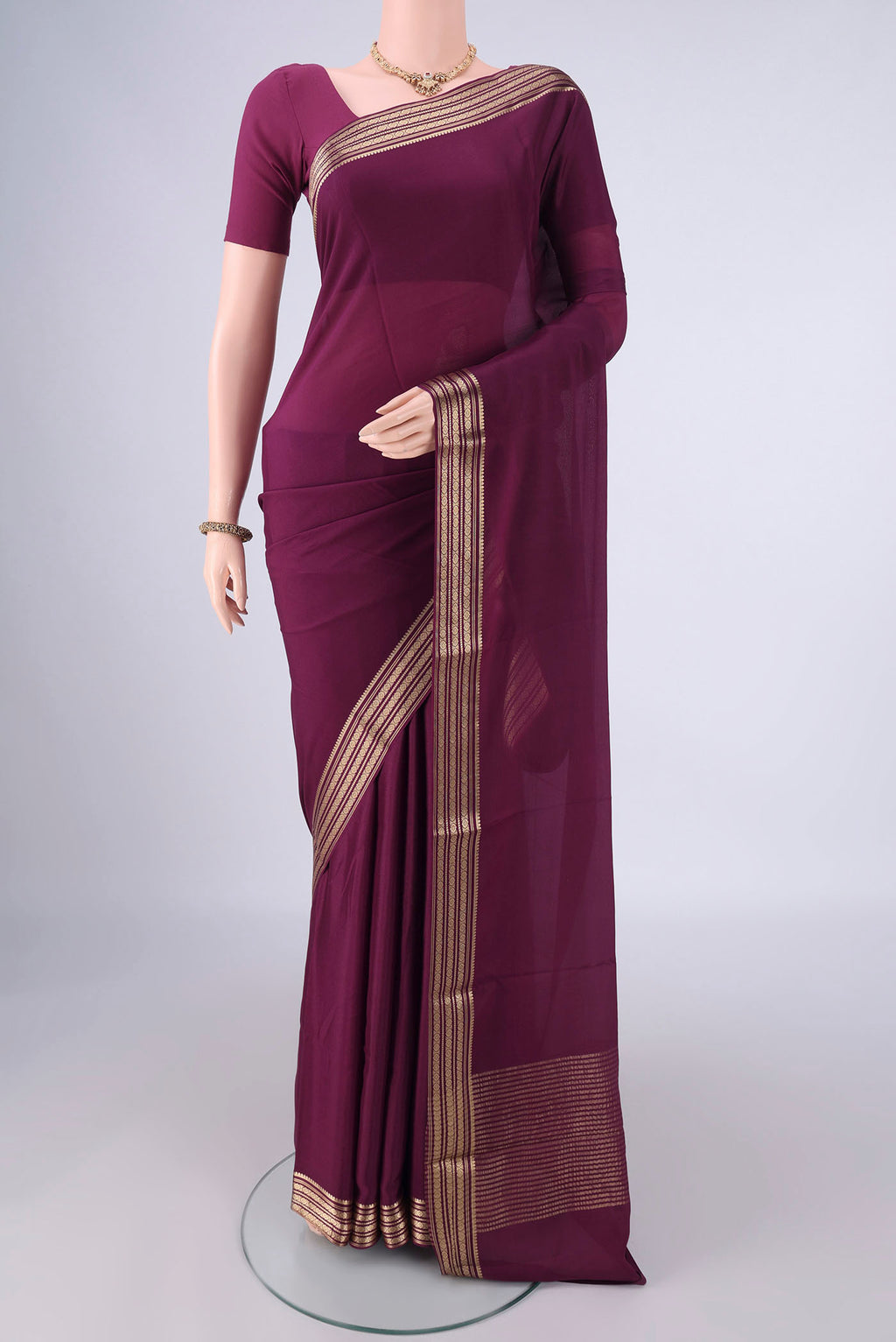 Burgundy Mysore Crepe Saree with Plain Body and Zari Border.  displayed on a mannequin