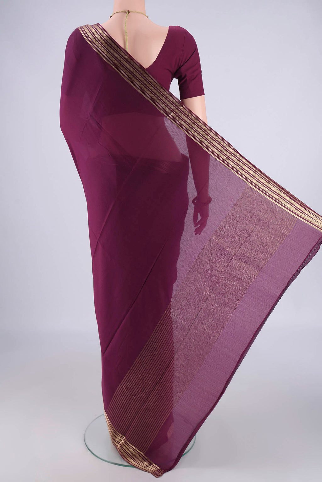 Flat view of Burgundy Mysore Crepe Saree with Plain Body and Zari Border. 