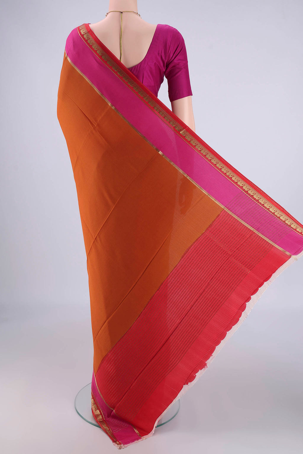 Flat view of Rust Mysore Crepe Saree with Plain Body and Zari Border. 