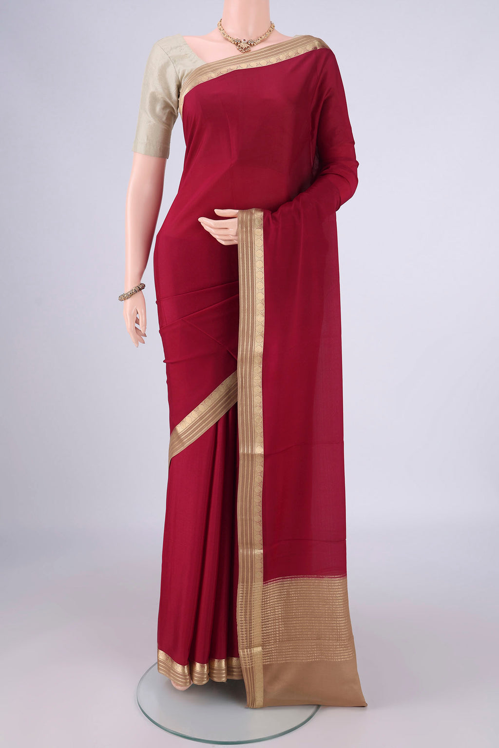 Maroon Mysore Crepe Saree with Plain Body and Zari Border.  displayed on a mannequin