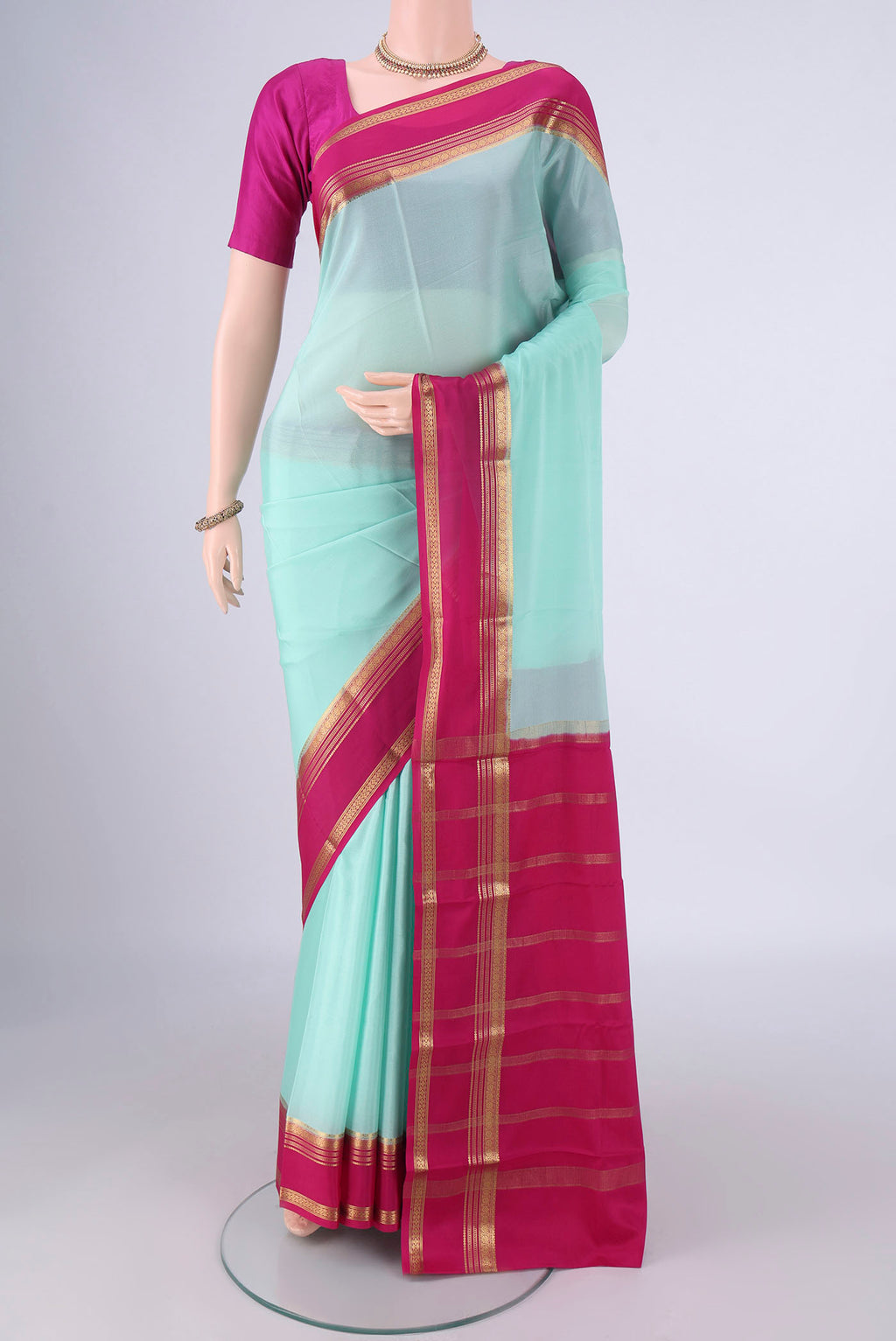 Light Blue Mysore Crepe Saree with Plain Body and Zari Border.  displayed on a mannequin