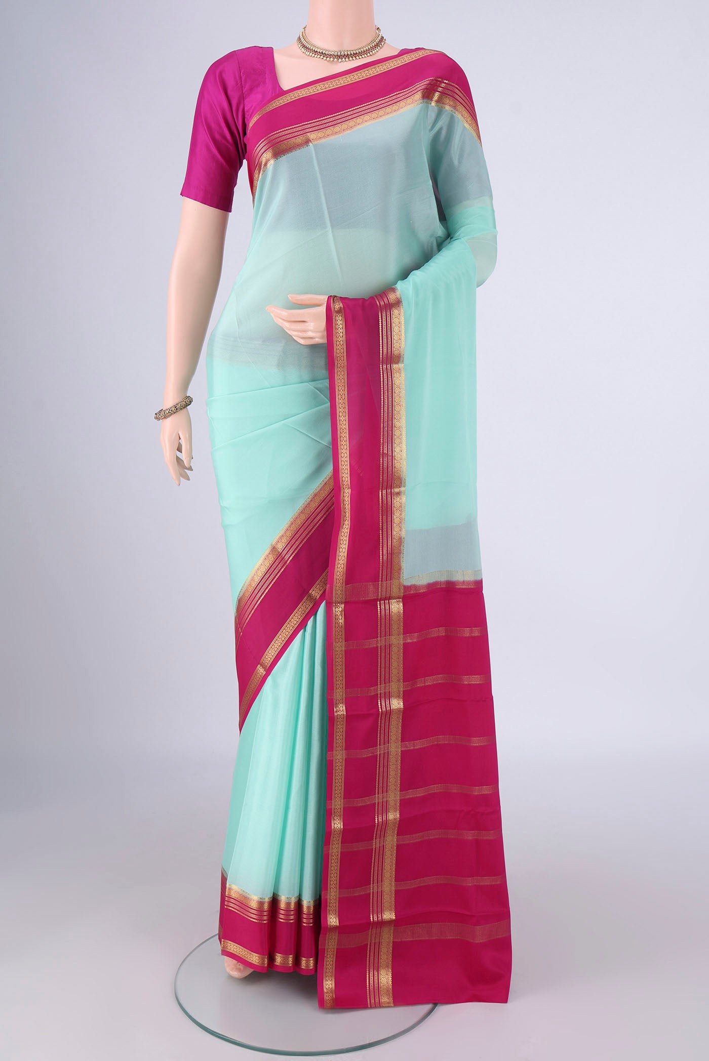 Light Blue Mysore Crepe Saree with Plain Body and Zari Border.  displayed on a mannequin