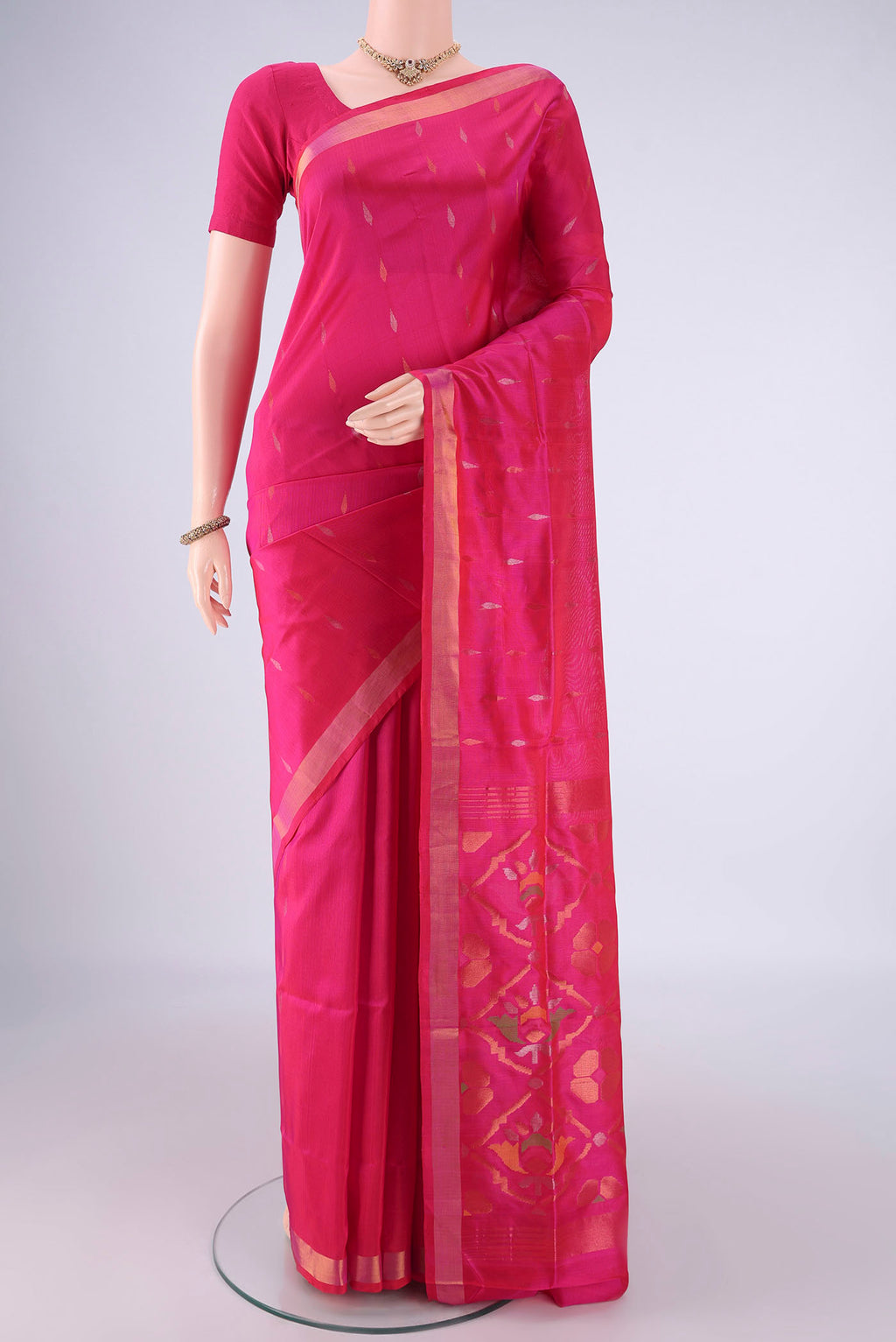 Rani Pink Uppada Silk Saree with Zari Butta on the body and Zari Border.  displayed on a mannequin