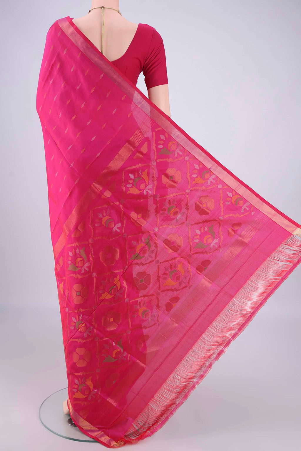 Flat view of Rani Pink Uppada Silk Saree with Zari Butta on the body and Zari Border. 