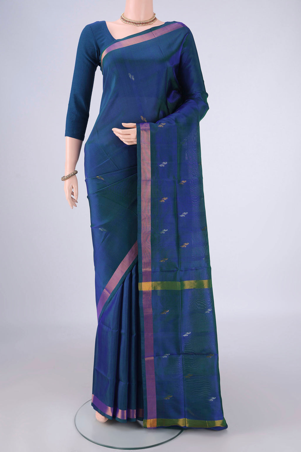 Turquoise Uppada Silk Saree with Zari Butta on the body and Zari Border.  displayed on a mannequin