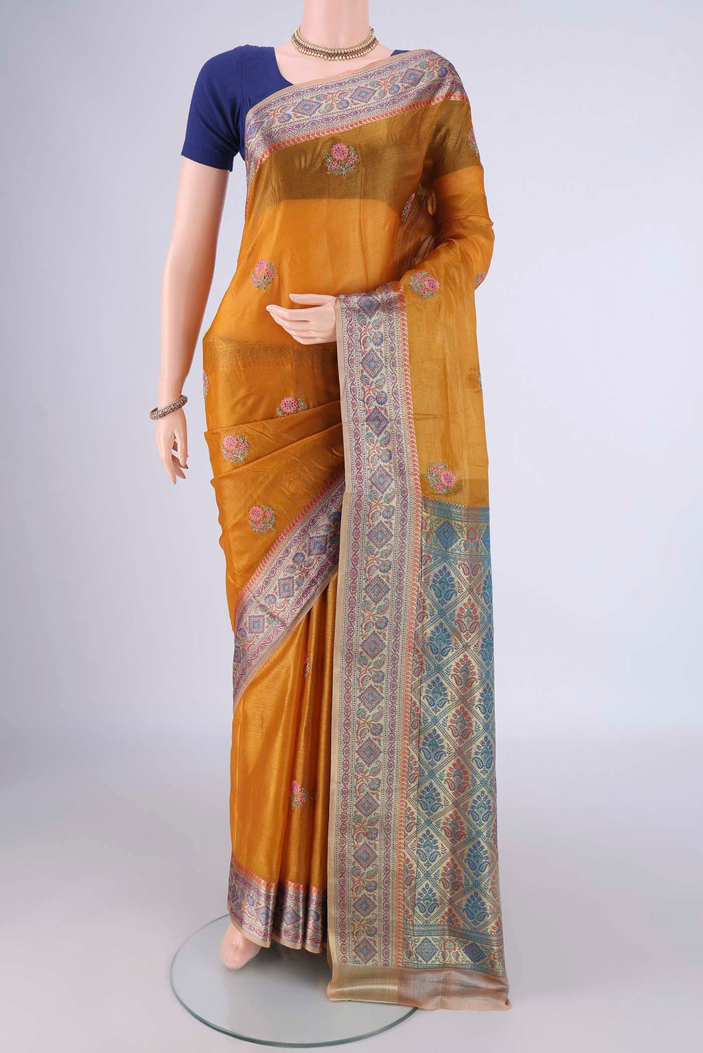 Mustard Banarasi Tussar Silk Saree with Embroidery on the body and Zari Border.  displayed on a mannequin