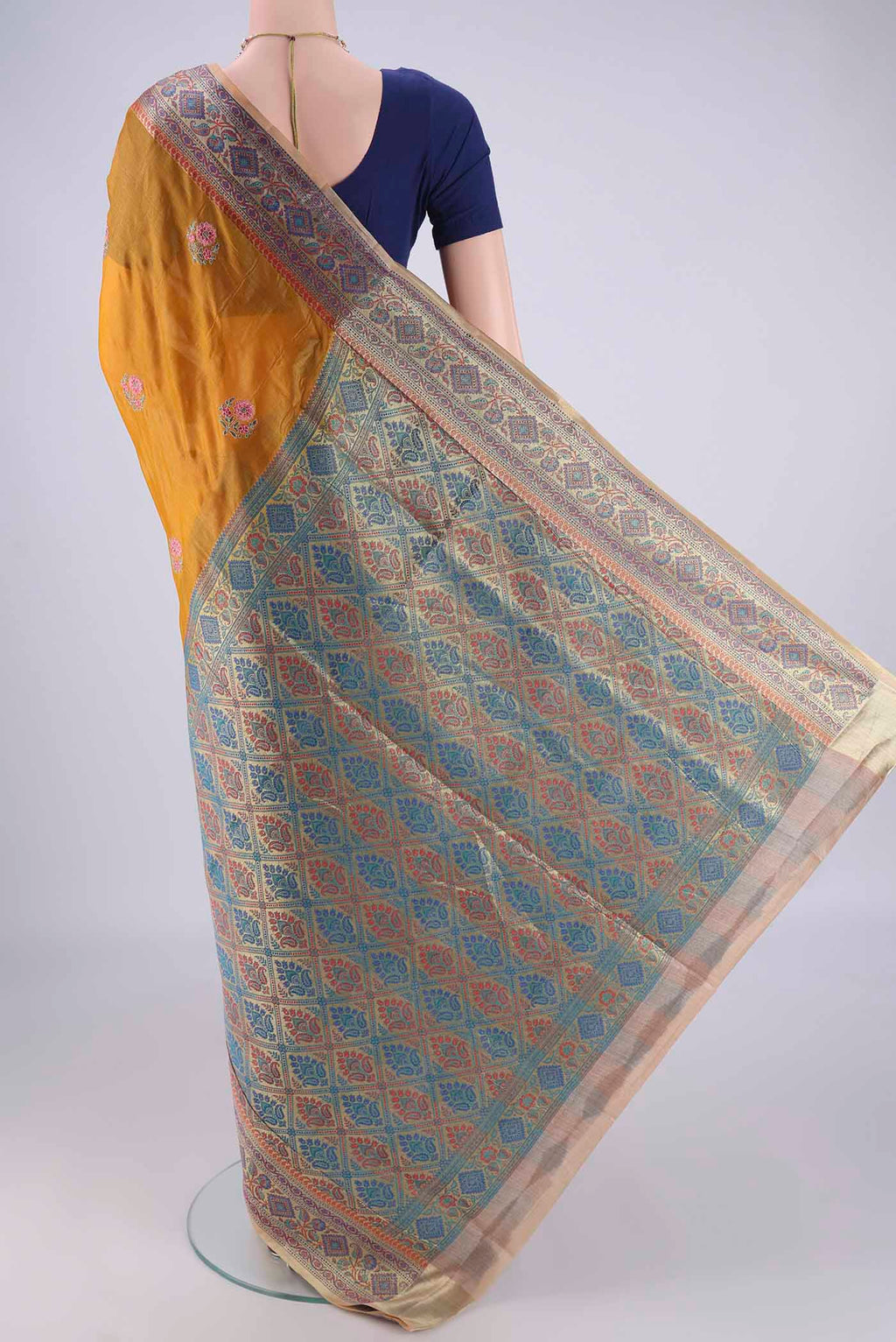 Flat view of Mustard Banarasi Tussar Silk Saree with Embroidery on the body and Zari Border. 