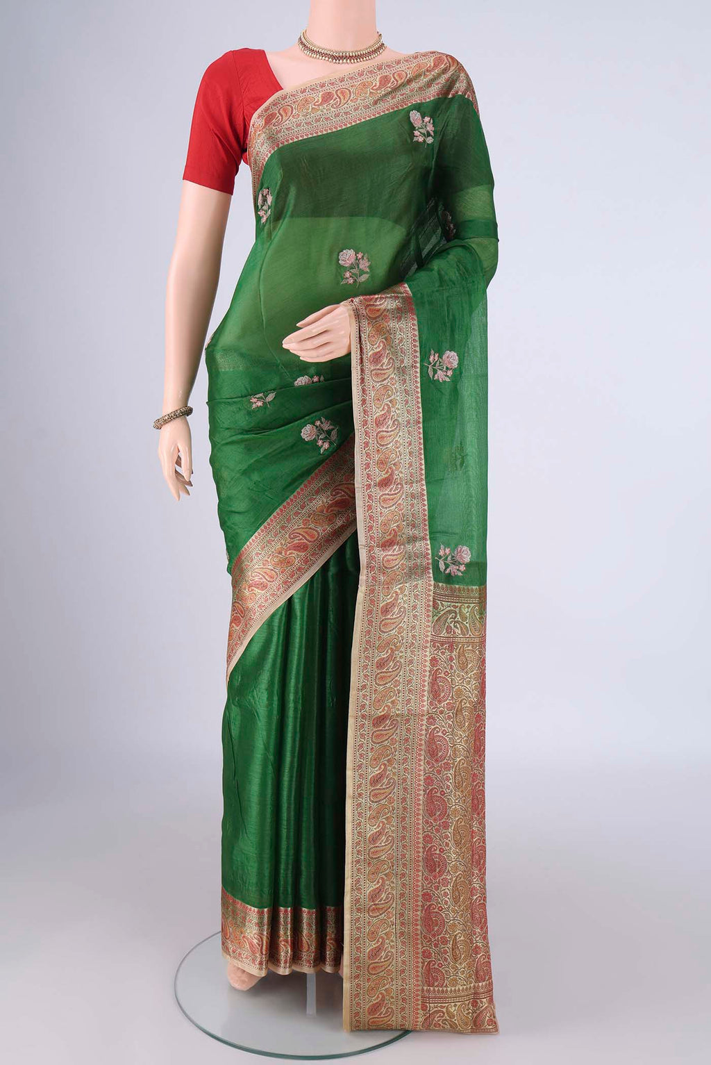 Green Banarasi Tussar Silk Saree with Embroidery on the body and Zari And Thread Border.  displayed on a mannequin