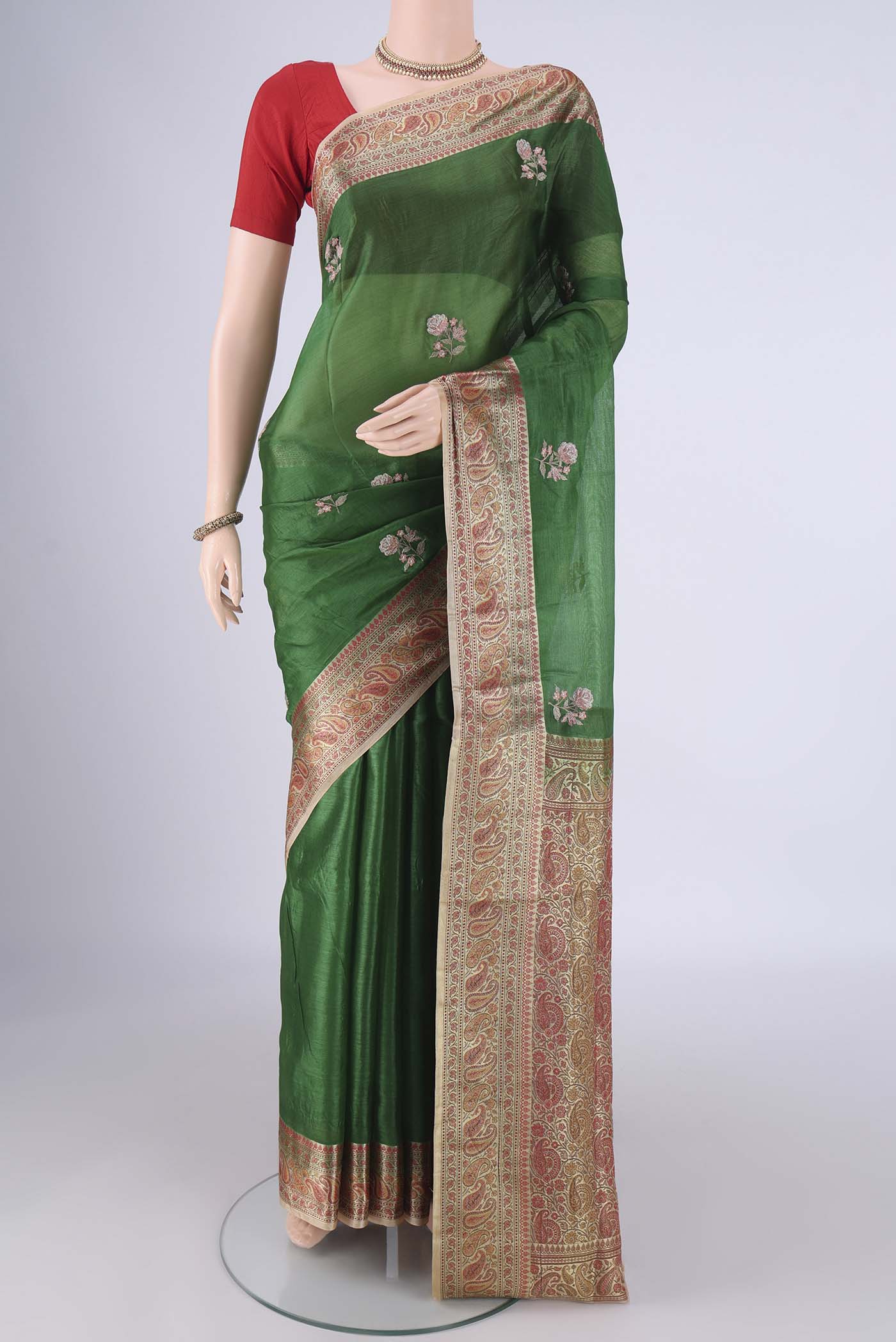 Green Banarasi Tussar Silk Saree with Embroidery on the body and Zari And Thread Border.  displayed on a mannequin