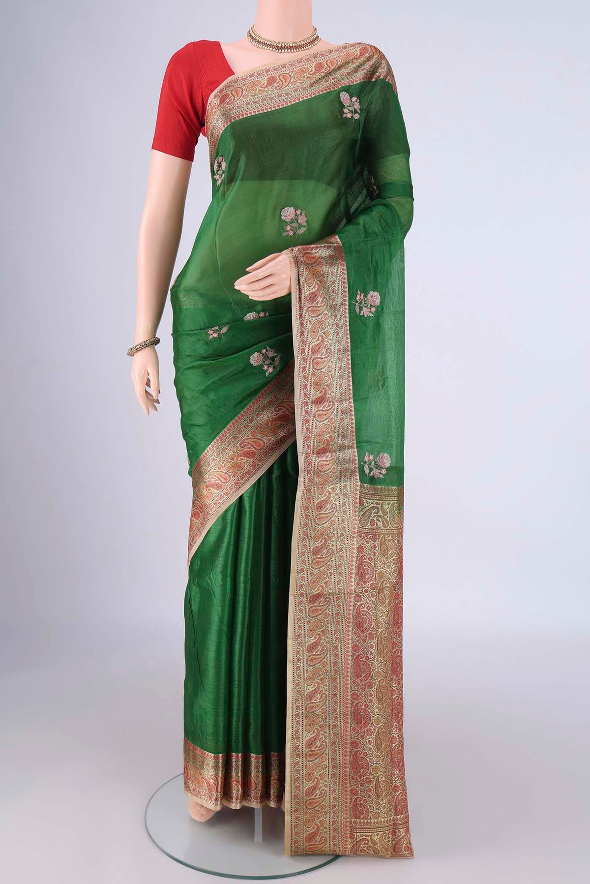 Green Banarasi Tussar Silk Saree with Embroidery on the body and Zari And Thread Border.  displayed on a mannequin