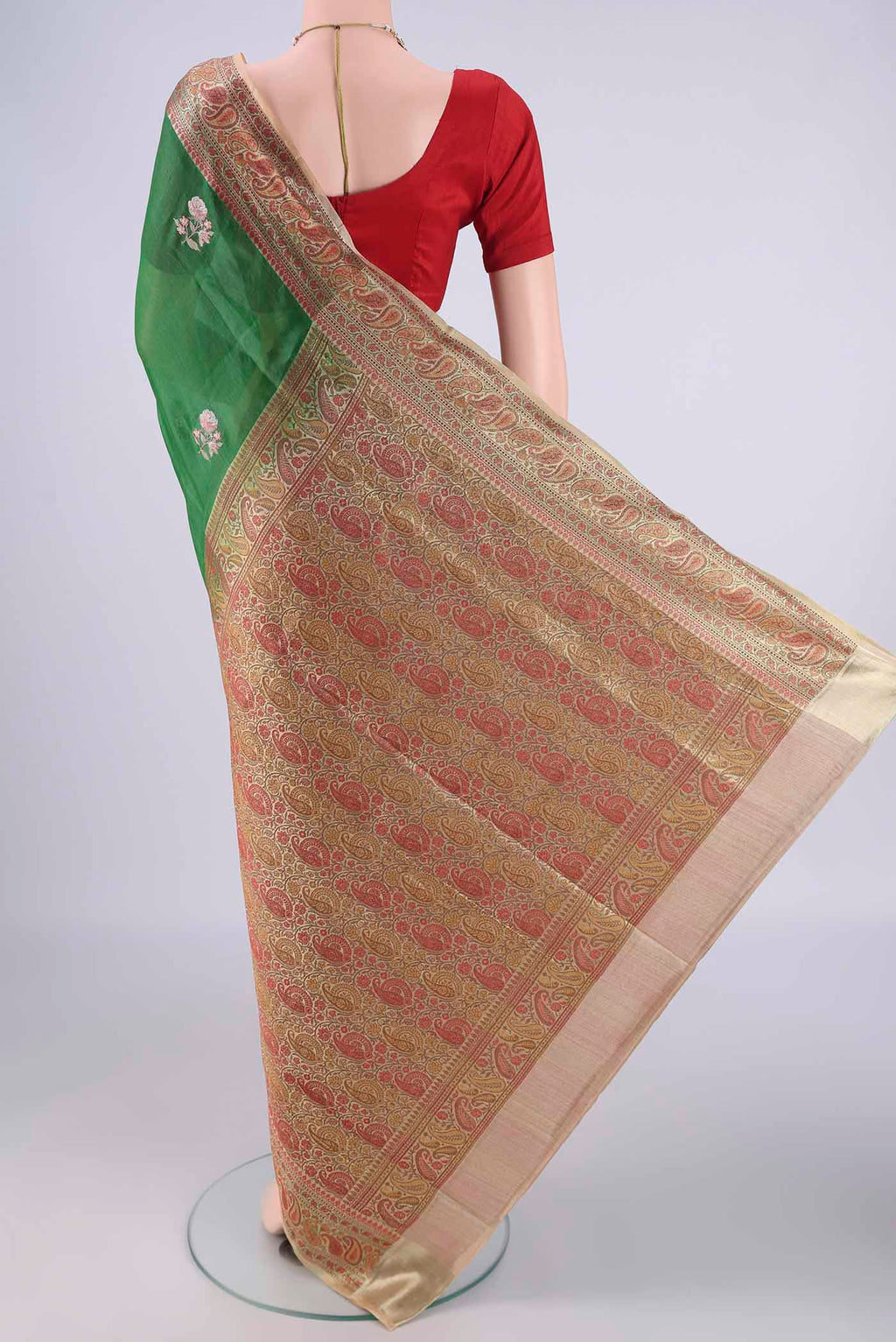 Flat view of Green Banarasi Tussar Silk Saree with Embroidery on the body and Zari And Thread Border. 