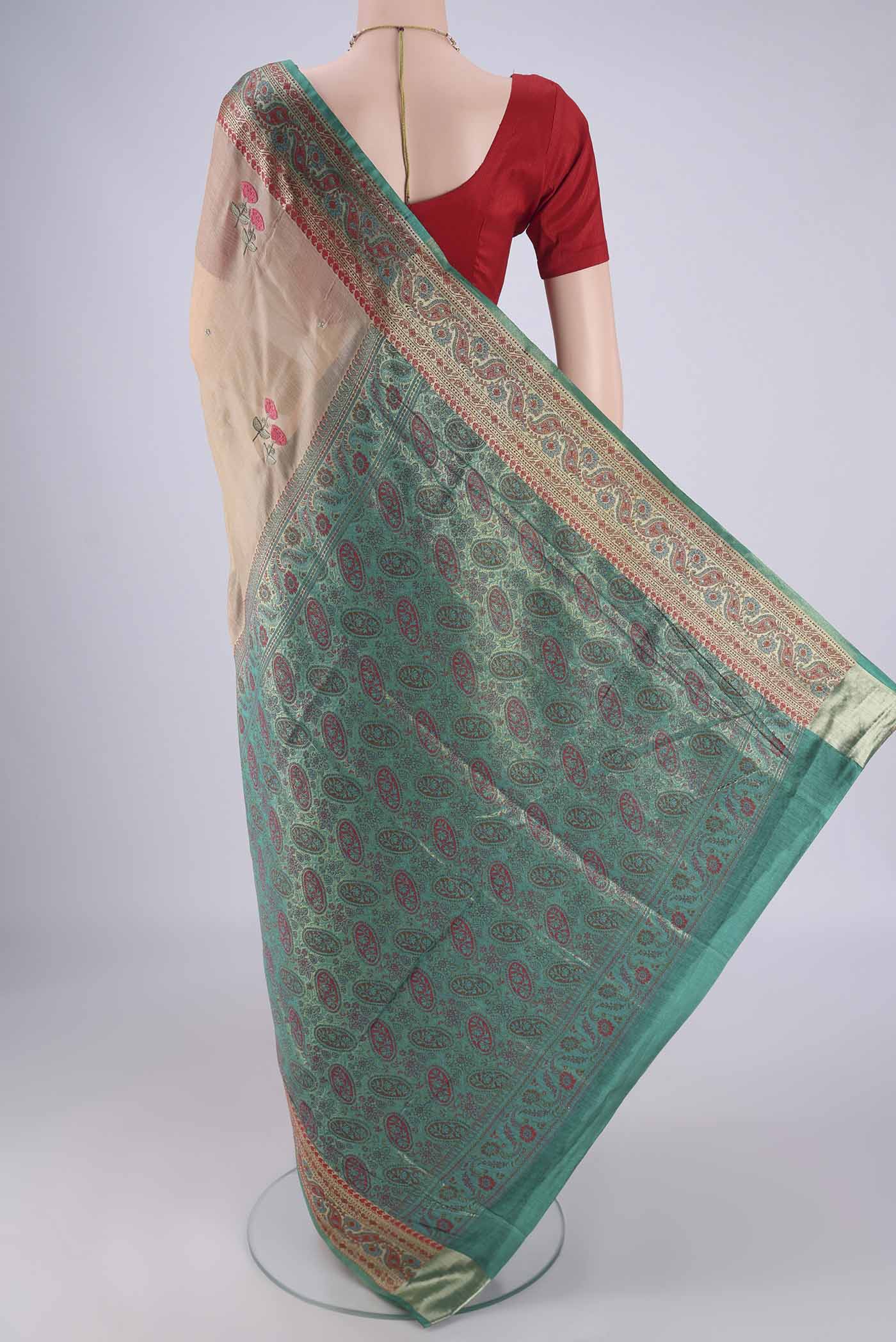 Flat view of Beige Banarasi Tussar Silk Saree with Embroidery on the body and Zari Border. 