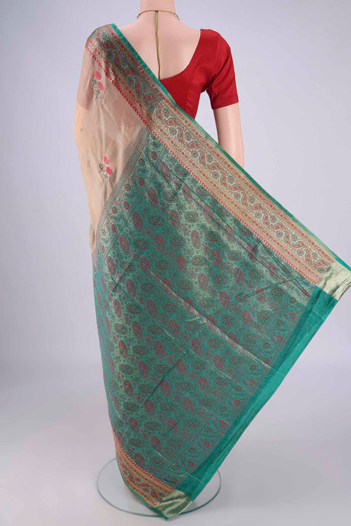 Flat view of Beige Banarasi Tussar Silk Saree with Embroidery on the body and Zari Border. 