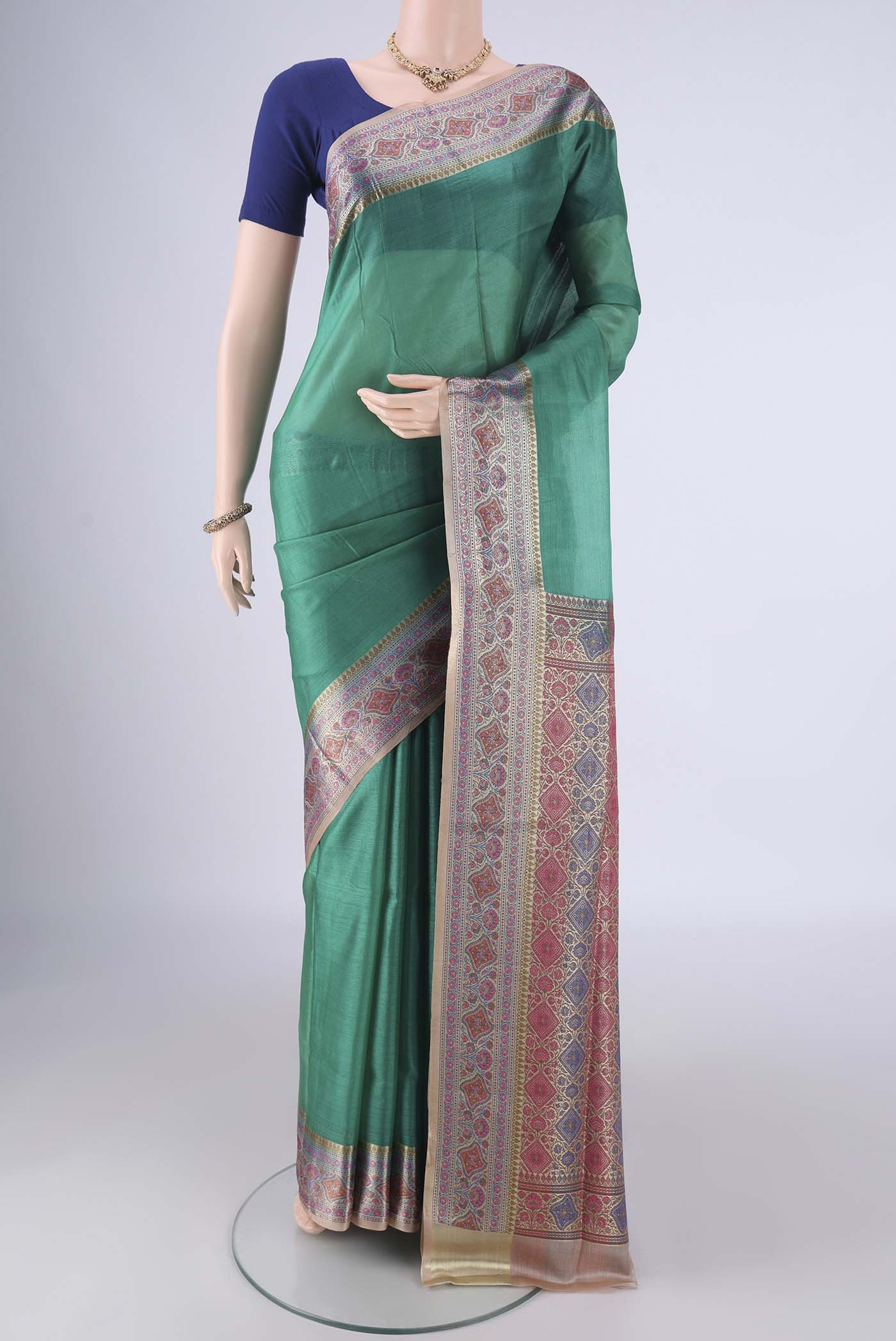 Sea Green Banarasi Tussar Silk Saree with Plain Body and Zari Border.  displayed on a mannequin