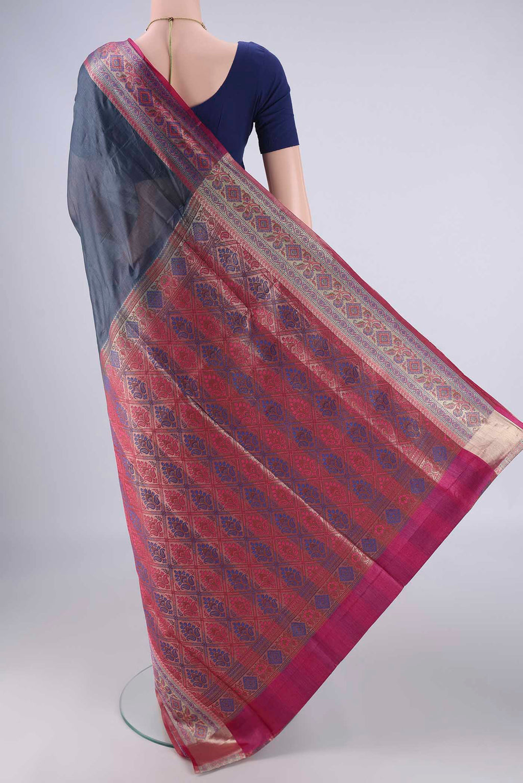 Flat view of Grey Banarasi Tussar Silk Saree with Plain Body and Zari Border. 
