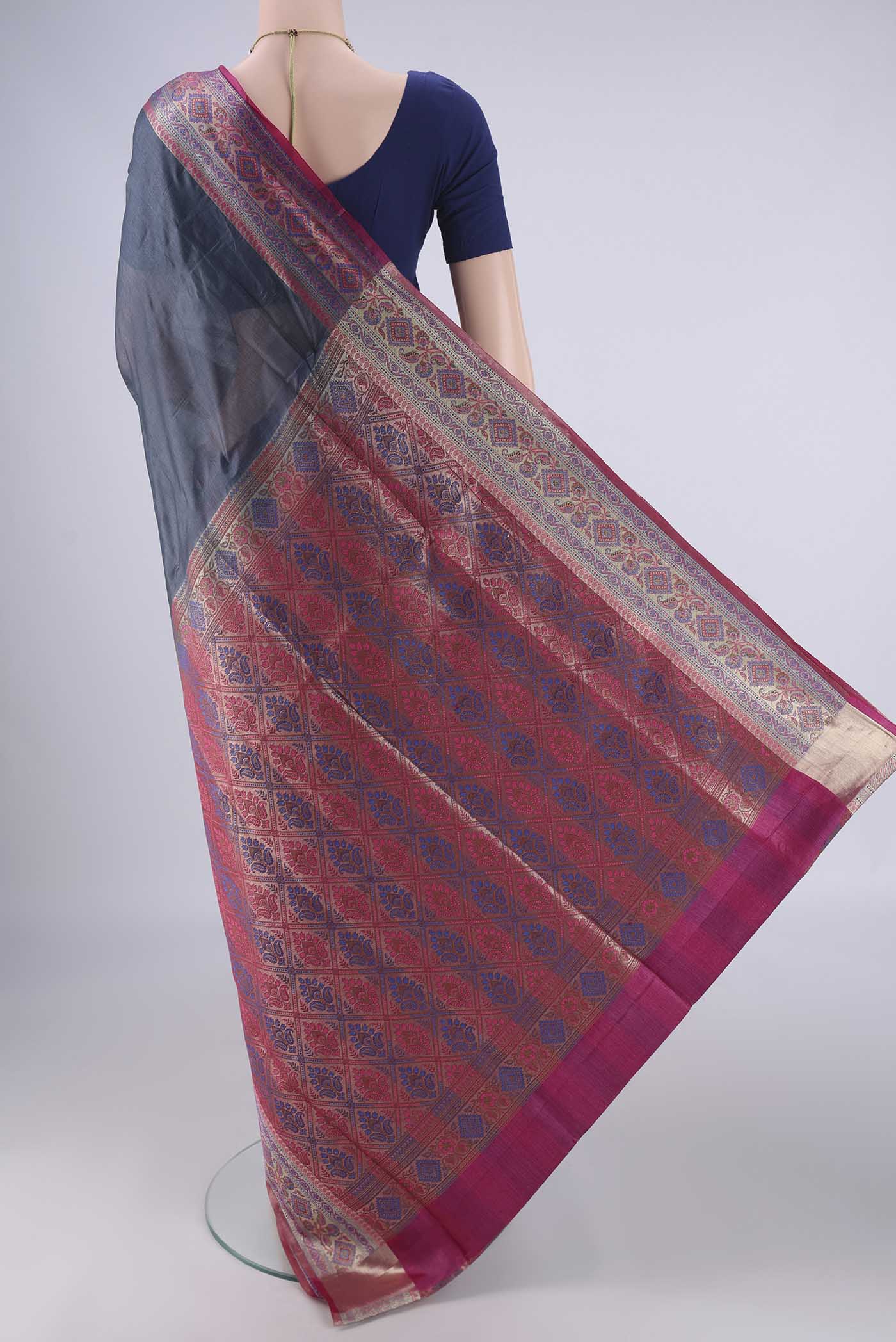 Flat view of Grey Banarasi Tussar Silk Saree with Plain Body and Zari Border. 