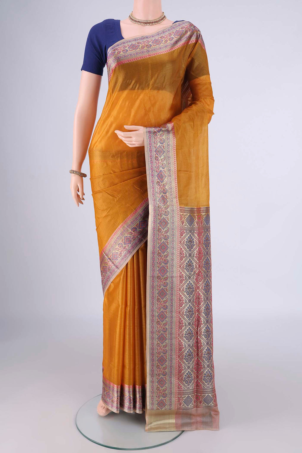 Mustard Banarasi Tussar Silk Saree with Plain Body and Zari Border.  displayed on a mannequin