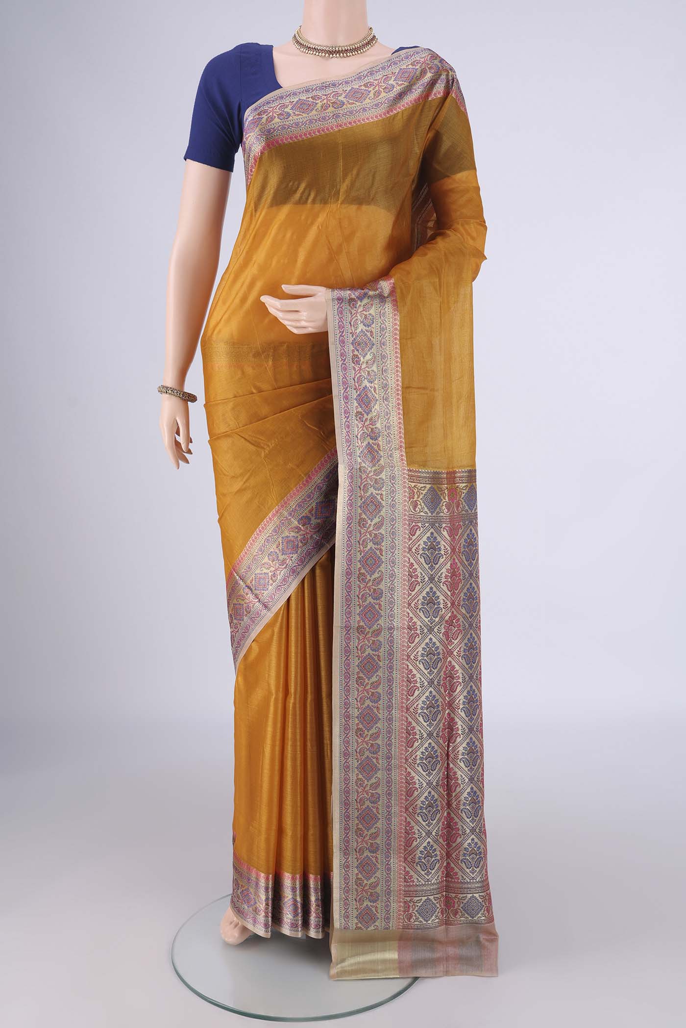 Mustard Banarasi Tussar Silk Saree with Plain Body and Zari Border.  displayed on a mannequin