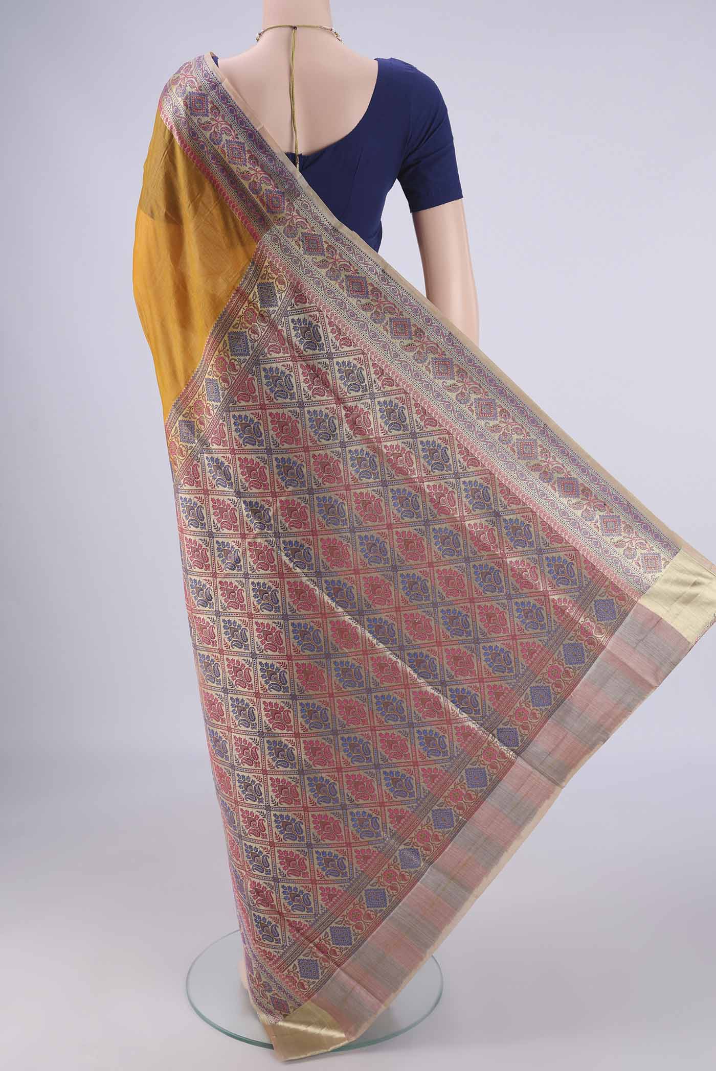 Flat view of Mustard Banarasi Tussar Silk Saree with Plain Body and Zari Border. 