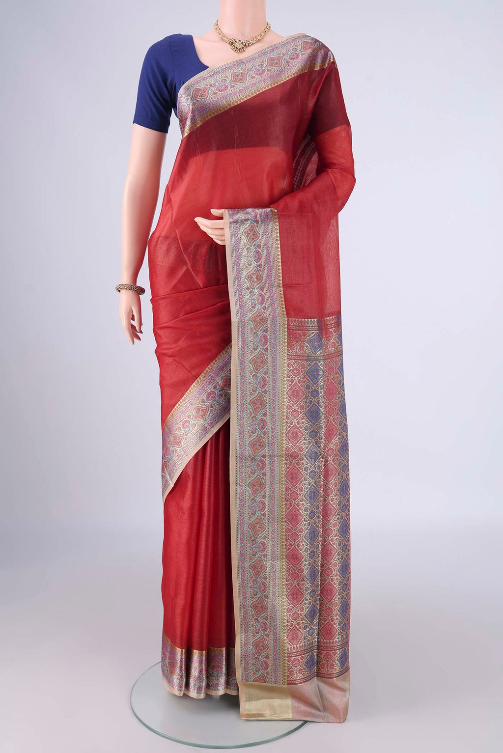 Rust Banarasi Tussar Silk Saree with Plain Body and Zari Border.  displayed on a mannequin
