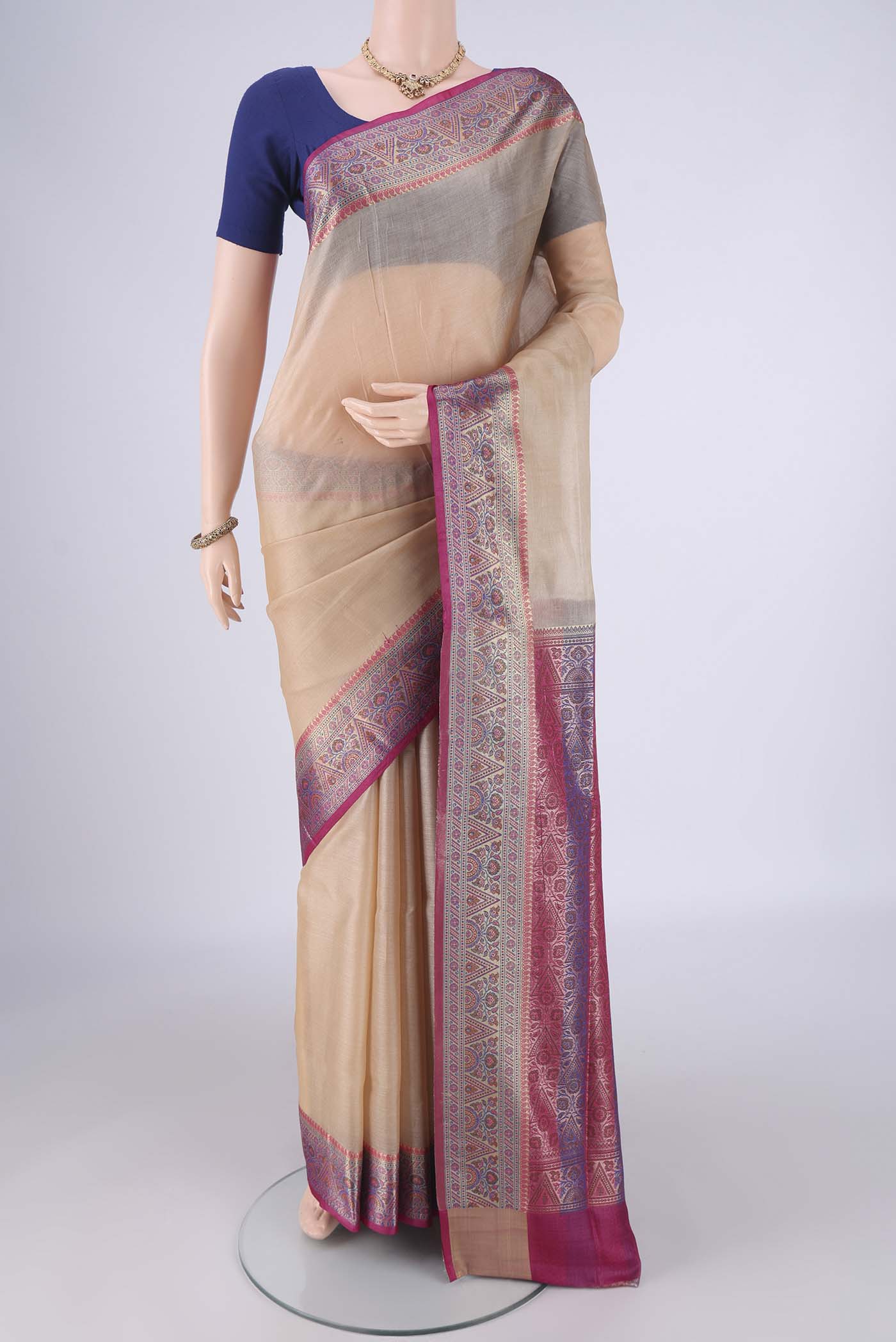 Beige Banarasi Tussar Silk Saree with Plain Body and Zari Border.  displayed on a mannequin