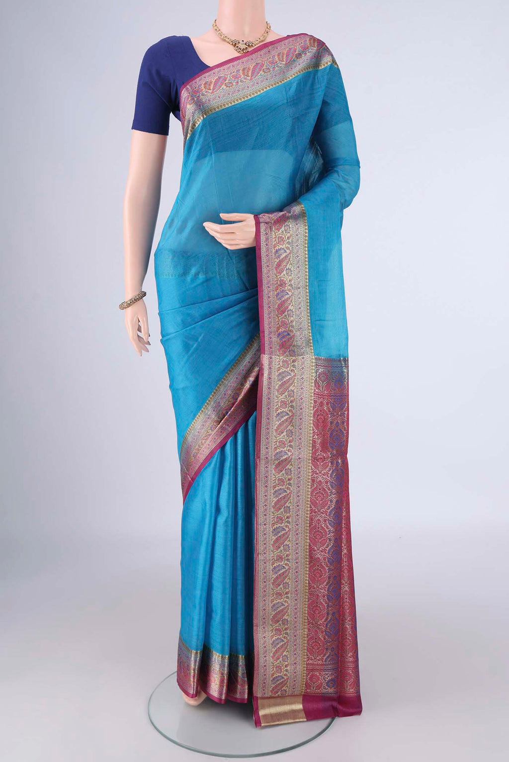 Blue Banarasi Tussar Silk Saree with Plain Body and Zari Border.  displayed on a mannequin