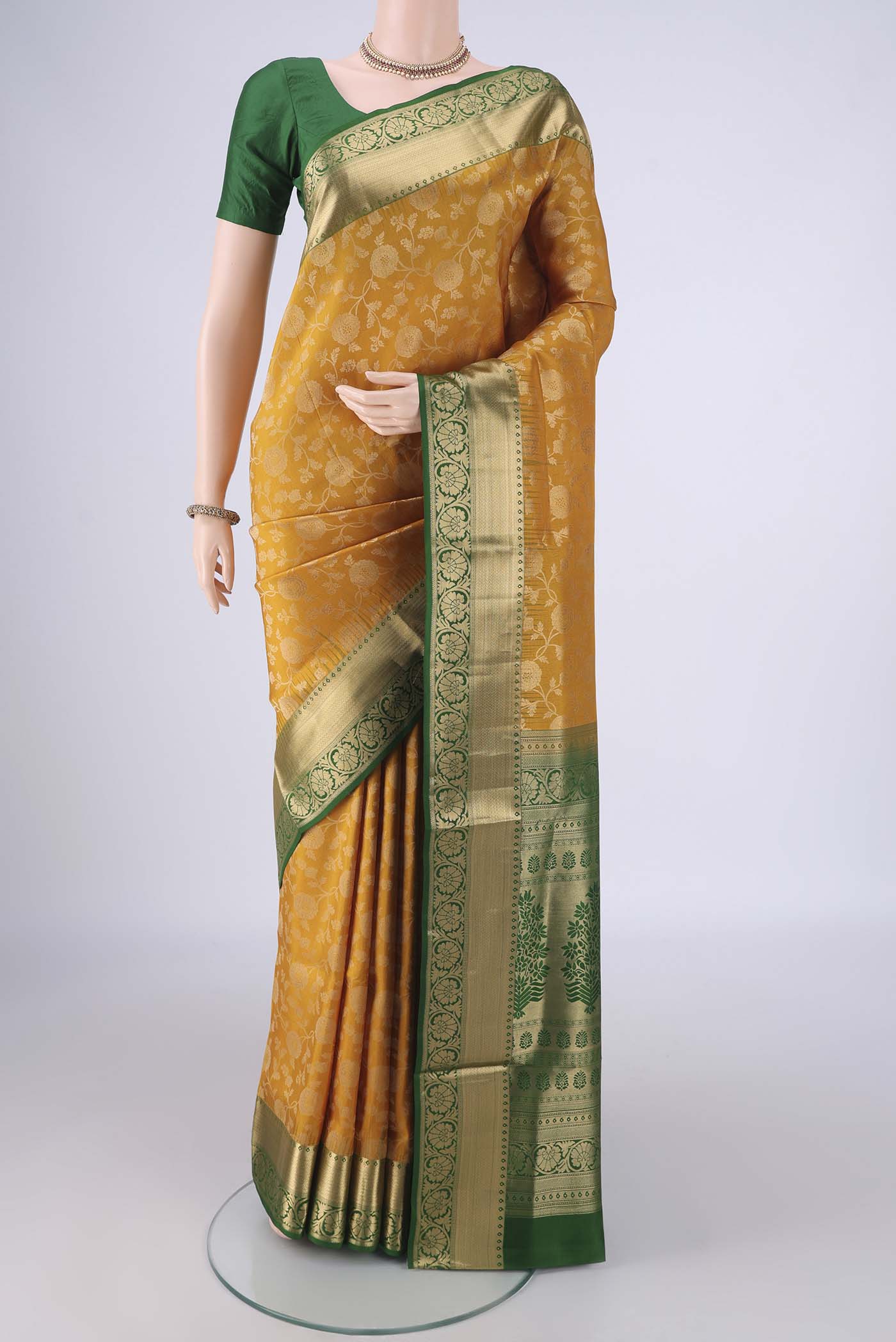 Mustard Soft Silk Saree with Zari Brocade on the body and Zari Border.  displayed on a mannequin