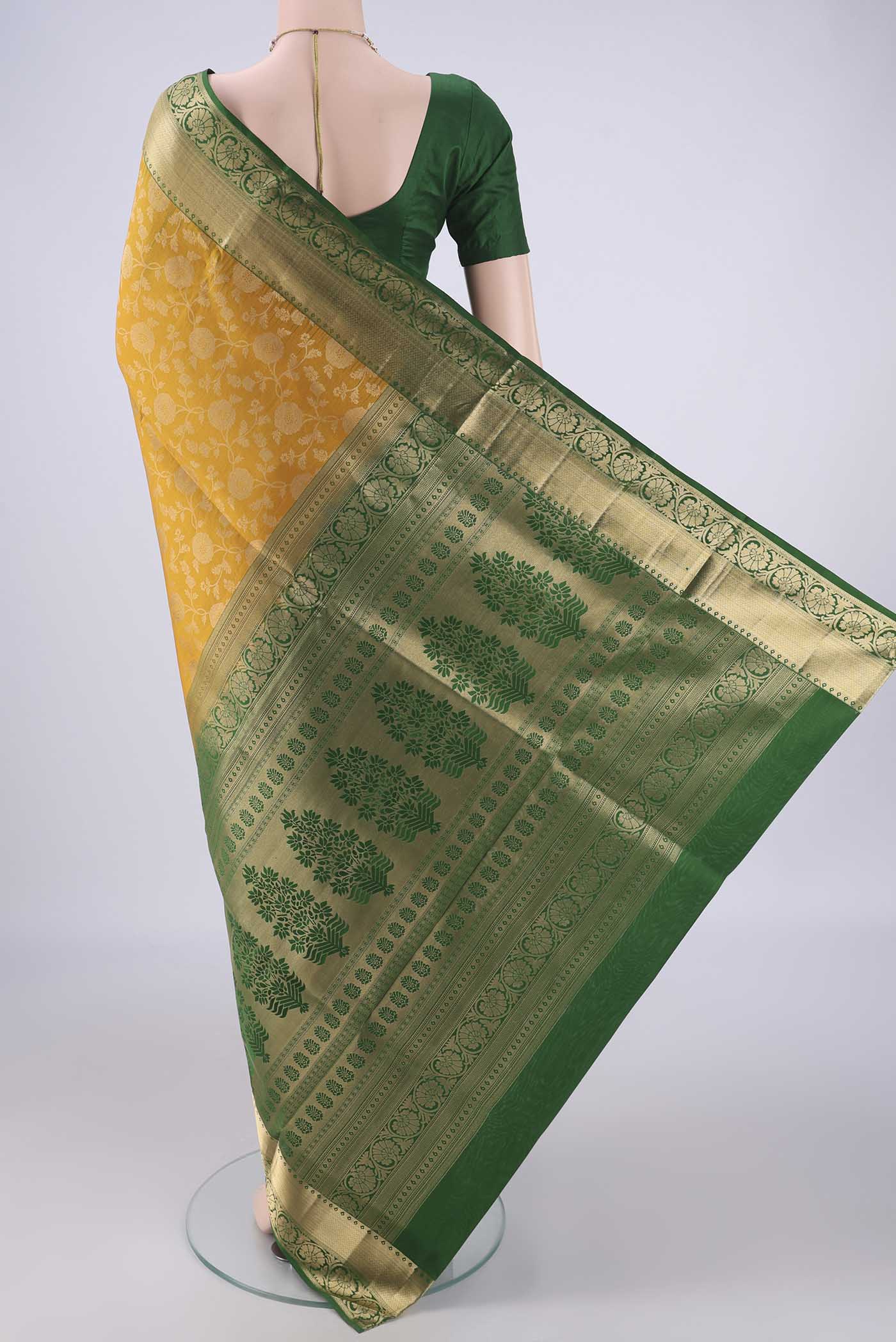 Flat view of Mustard Soft Silk Saree with Zari Brocade on the body and Zari Border. 