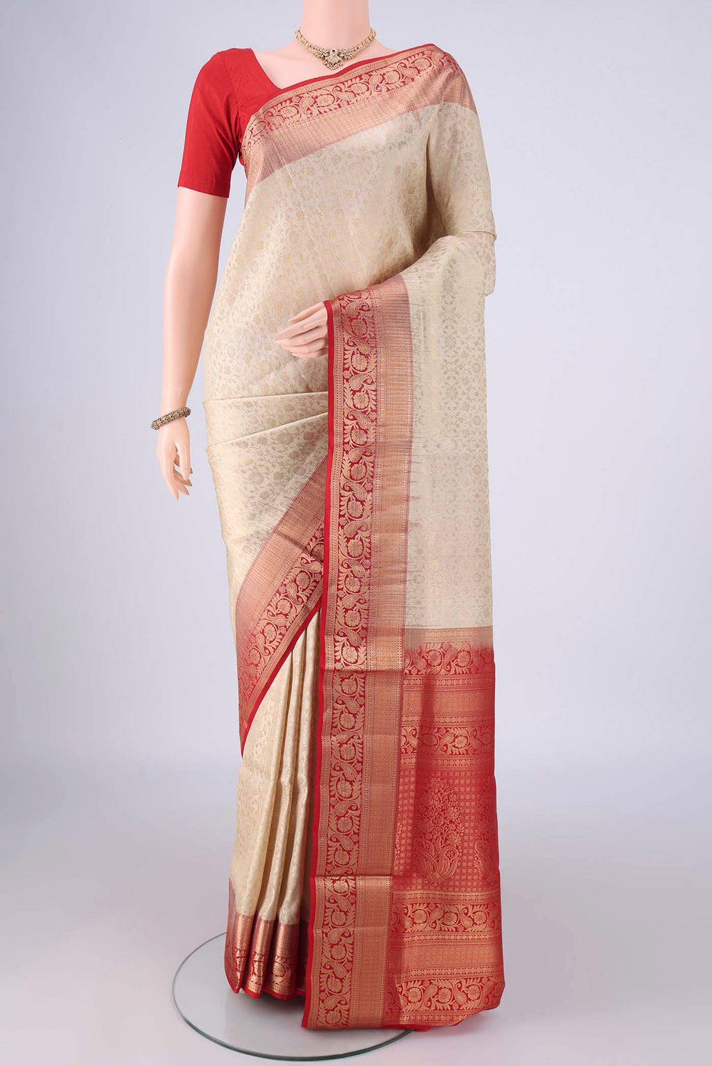 Off White Soft Silk Saree with Zari Brocade on the body and Zari Border.  displayed on a mannequin