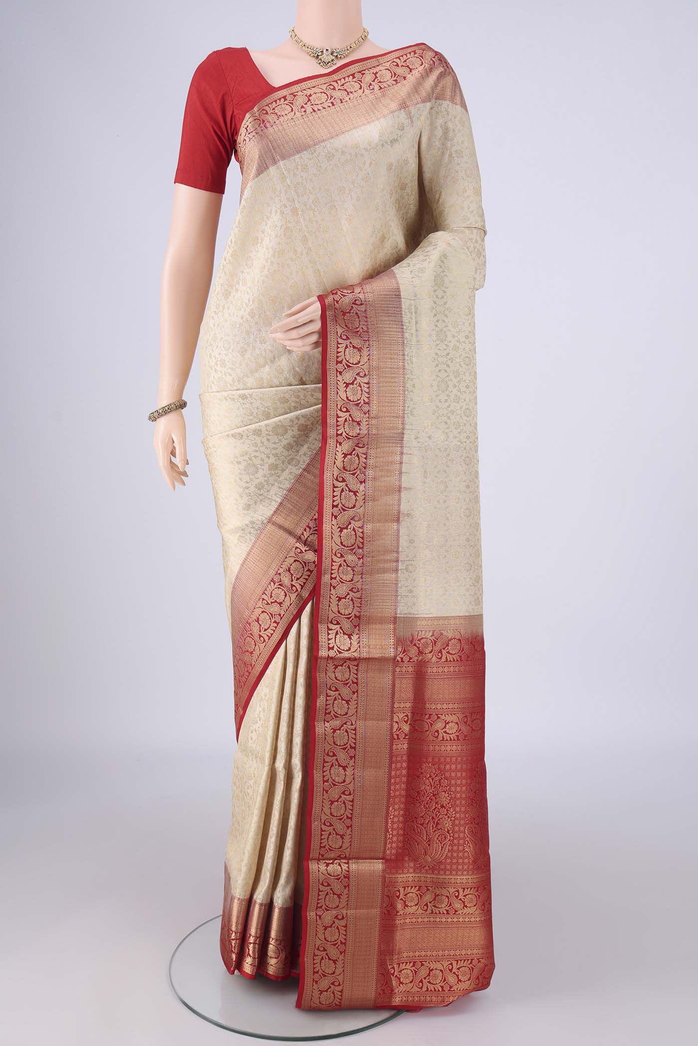 Off White Soft Silk Saree with Zari Brocade on the body and Zari Border.  displayed on a mannequin