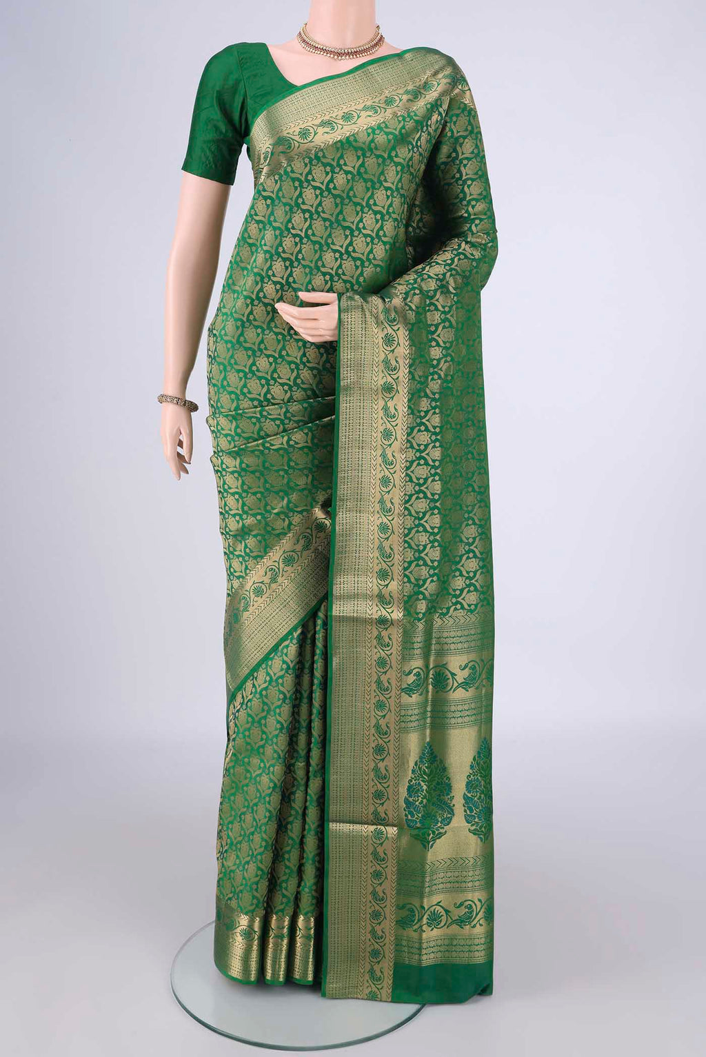 Green Soft Silk Saree with Zari Brocade on the body and Zari Border.  displayed on a mannequin