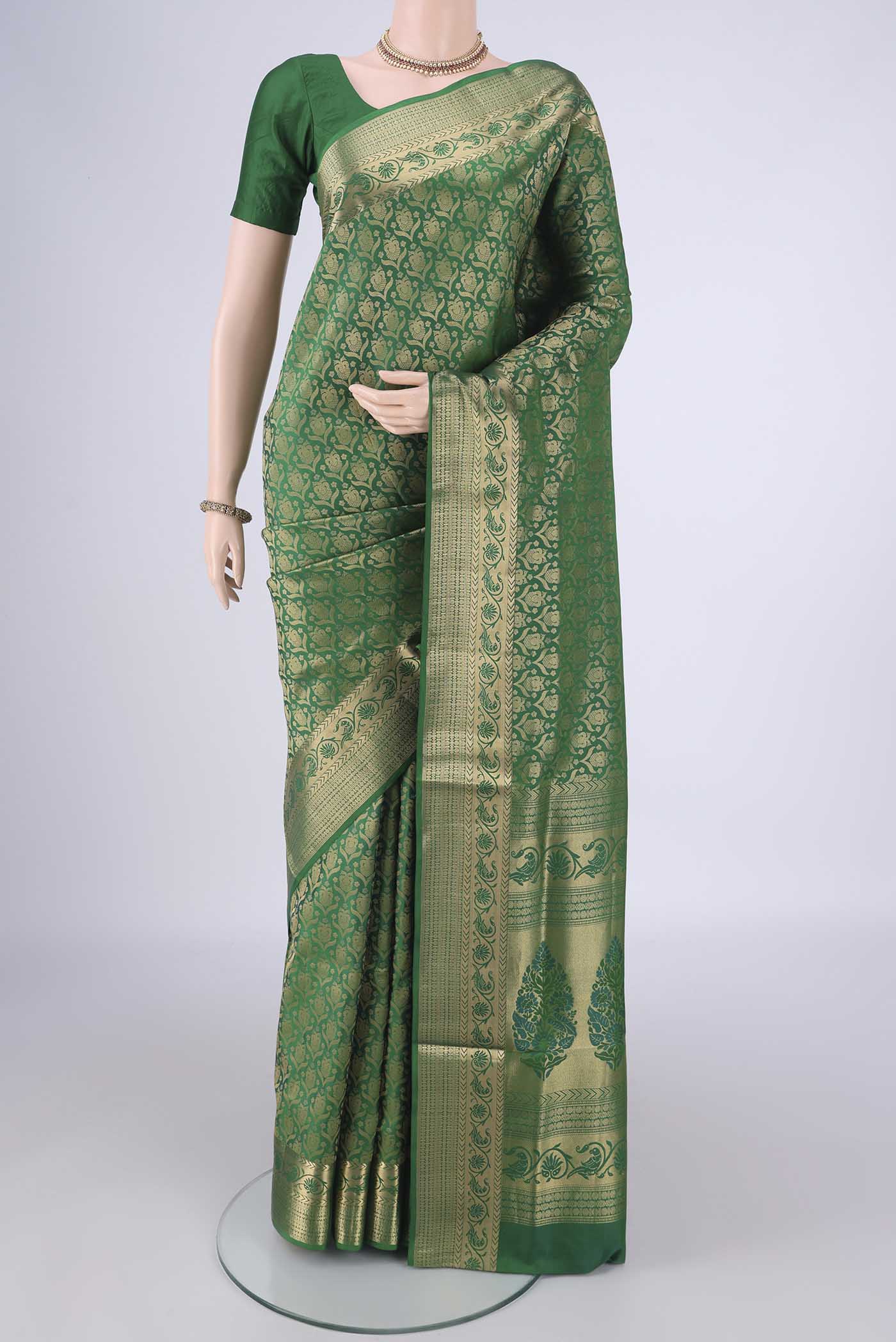 Green Soft Silk Saree with Zari Brocade on the body and Zari Border.  displayed on a mannequin