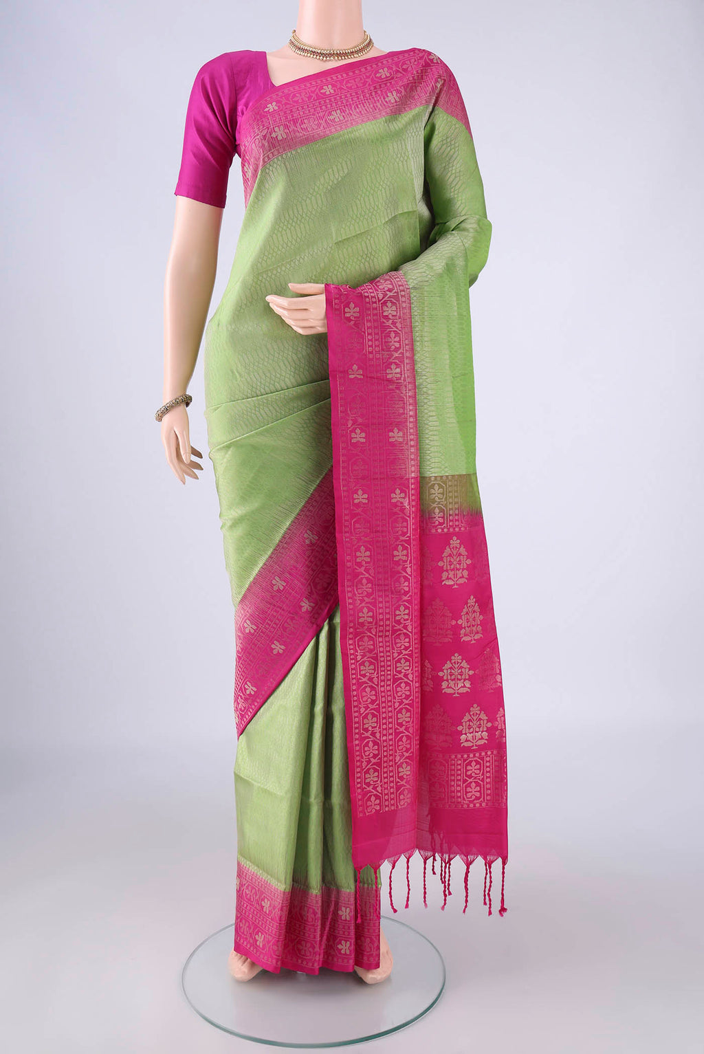 Light Green Soft Silk Saree with Zari Brocade on the body and Zari Border.  displayed on a mannequin