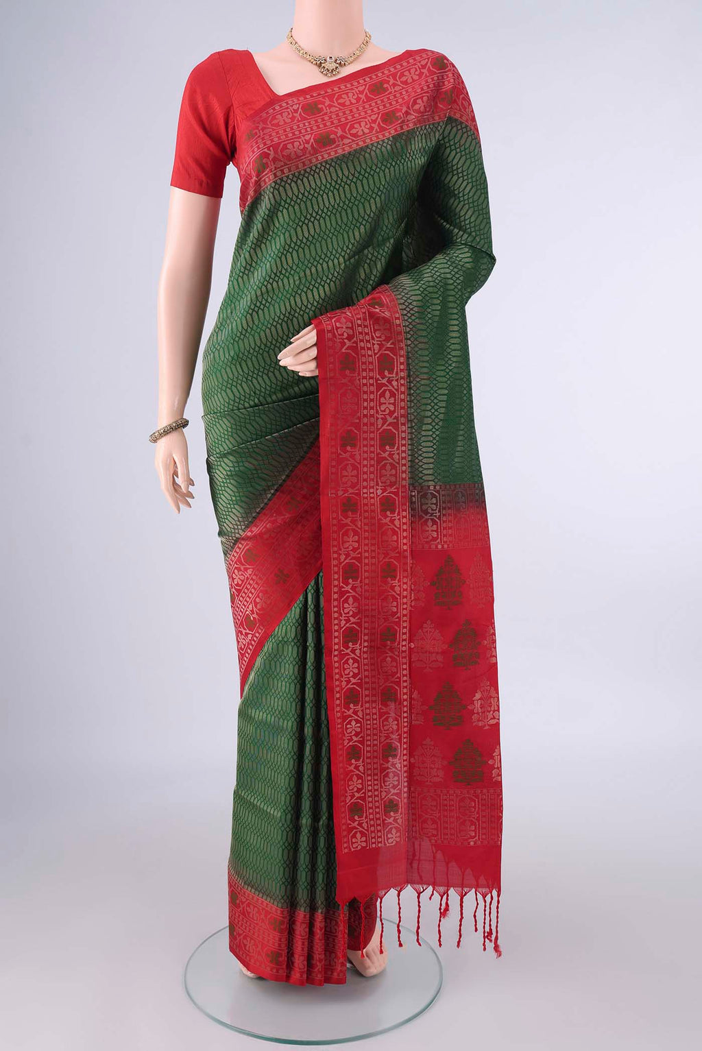 Pure Silk Bottle Green Soft Saree with Zari Brocade on the body and Zari And Thread Border.  displayed on a mannequin