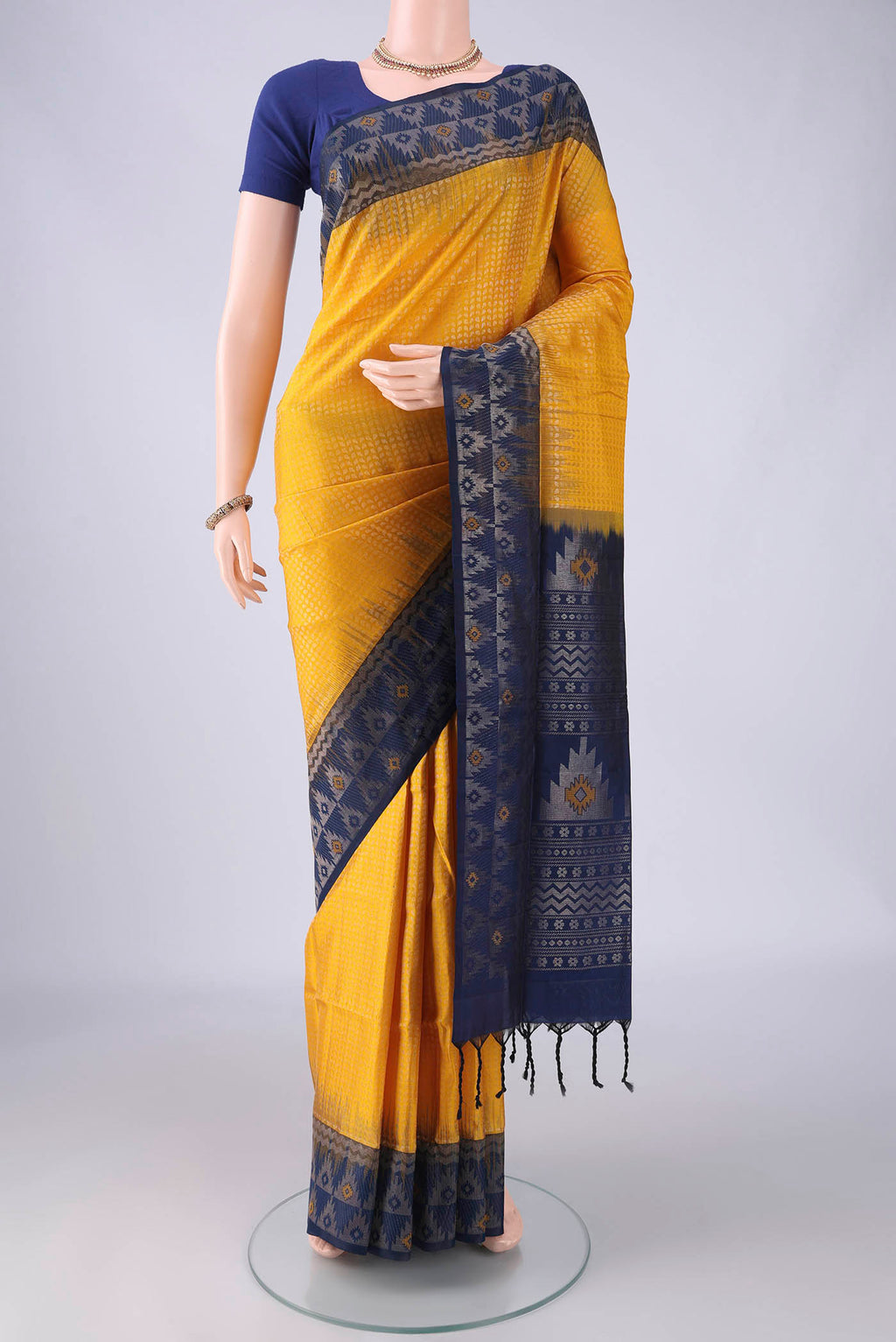 Yellow Soft Silk Saree with Zari Brocade on the body and Zari Border.  displayed on a mannequin