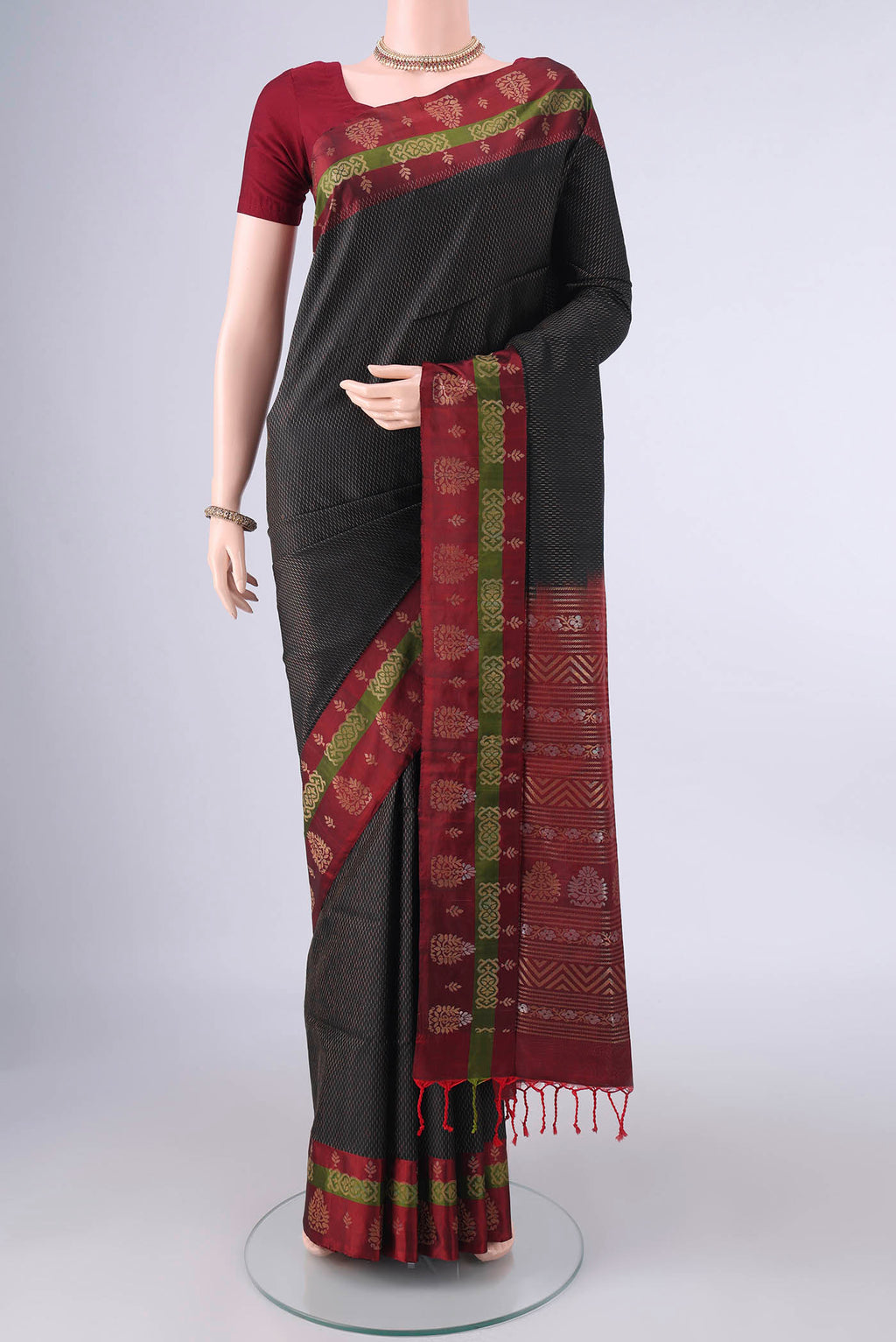 Pure Silk Black Soft Saree with Zari Brocade on the body and Zari Border.  displayed on a mannequin