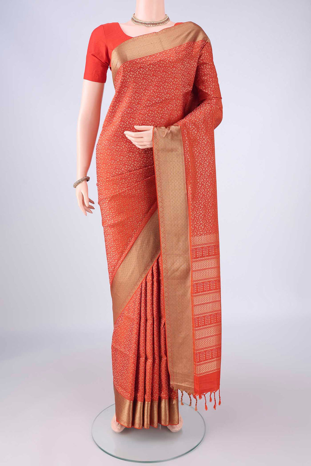 Rust Soft Silk Saree with Thread Brocade on the body and Thread Border.  displayed on a mannequin
